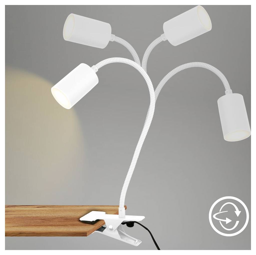 Schreibtischlampe zum Anklemmen mit vier verstellbaren zylinderförmigen Leuchten an einer Schreibtischkante befestigt, eine Lampe beleuchtet.
