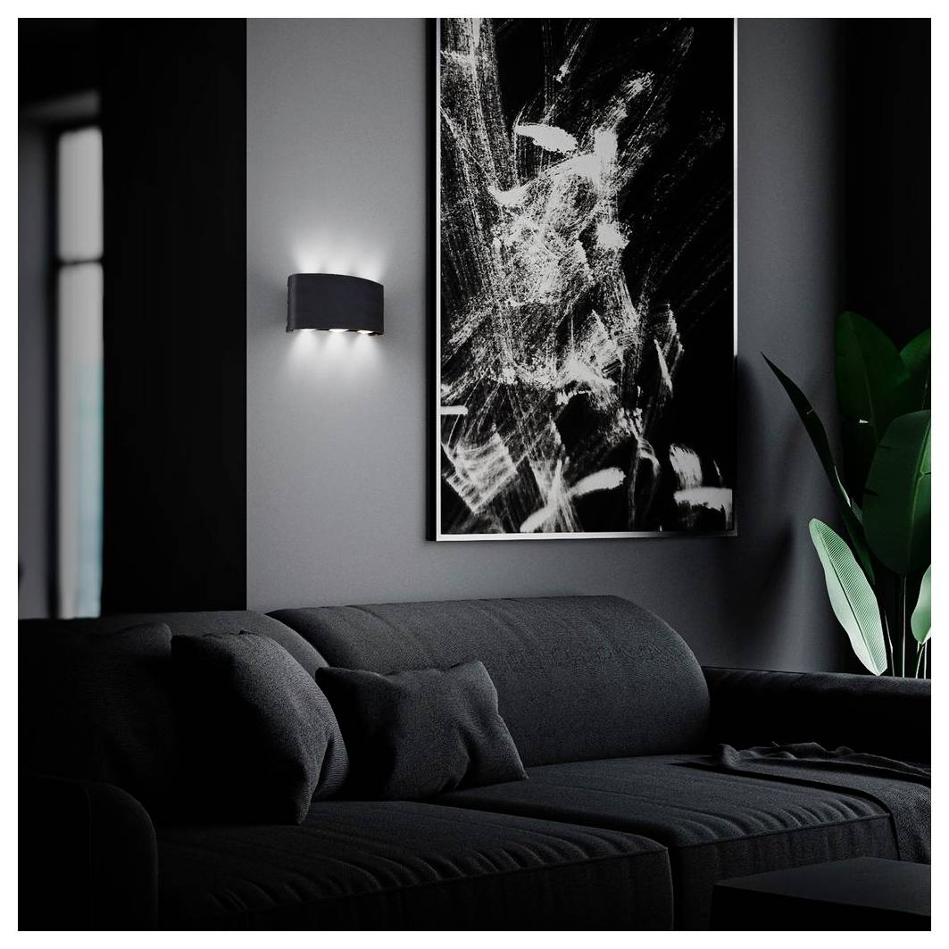 Dunkles modernes Wohnzimmer mit schwarzem Ecksofa, abstrakter Wandkunst, Wandleuchte und einer hohen Blattplanze.