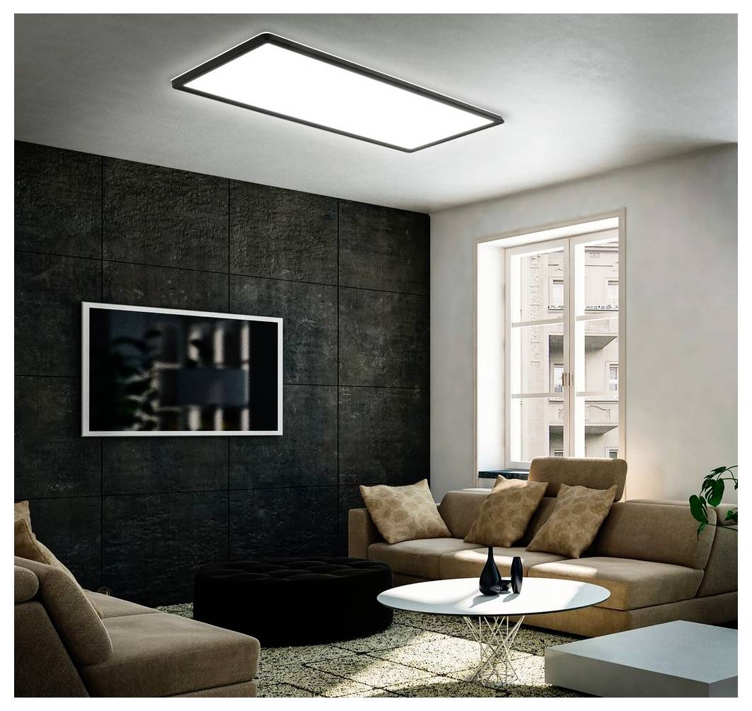 Modernes Wohnzimmer mit beigefarbenen Sofas, rundem weißem Couchtisch, an der Wand montiertem Fernseher, großem Fenster und dunkler Akzentwand mit Deckenleuchte.