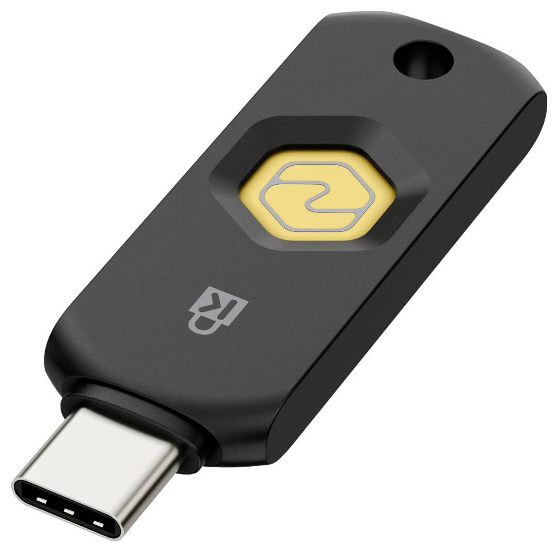 Schwarzer USB-C-Sicherheitsschlüssel mit gelbem sechseckigem Tastknopf und Schlüsselloch, dargestellt auf weißem Hintergrund.