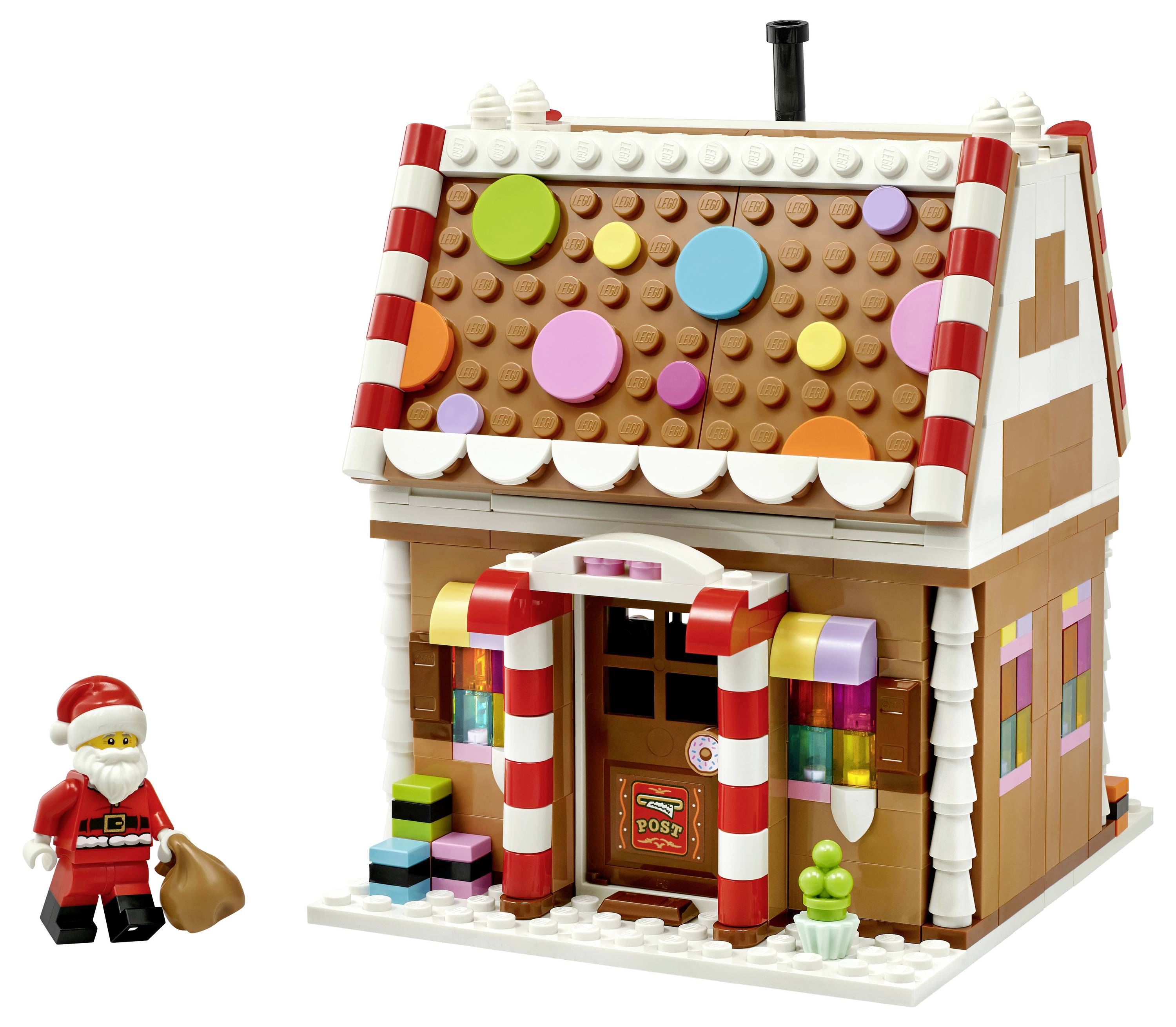 LEGO-Lebkuchenhaus-Postamt im Stil mit bonbonfarbigen Dachpunkten und einer Weihnachtsmann-Minifigur, die einen Sack daneben hält.