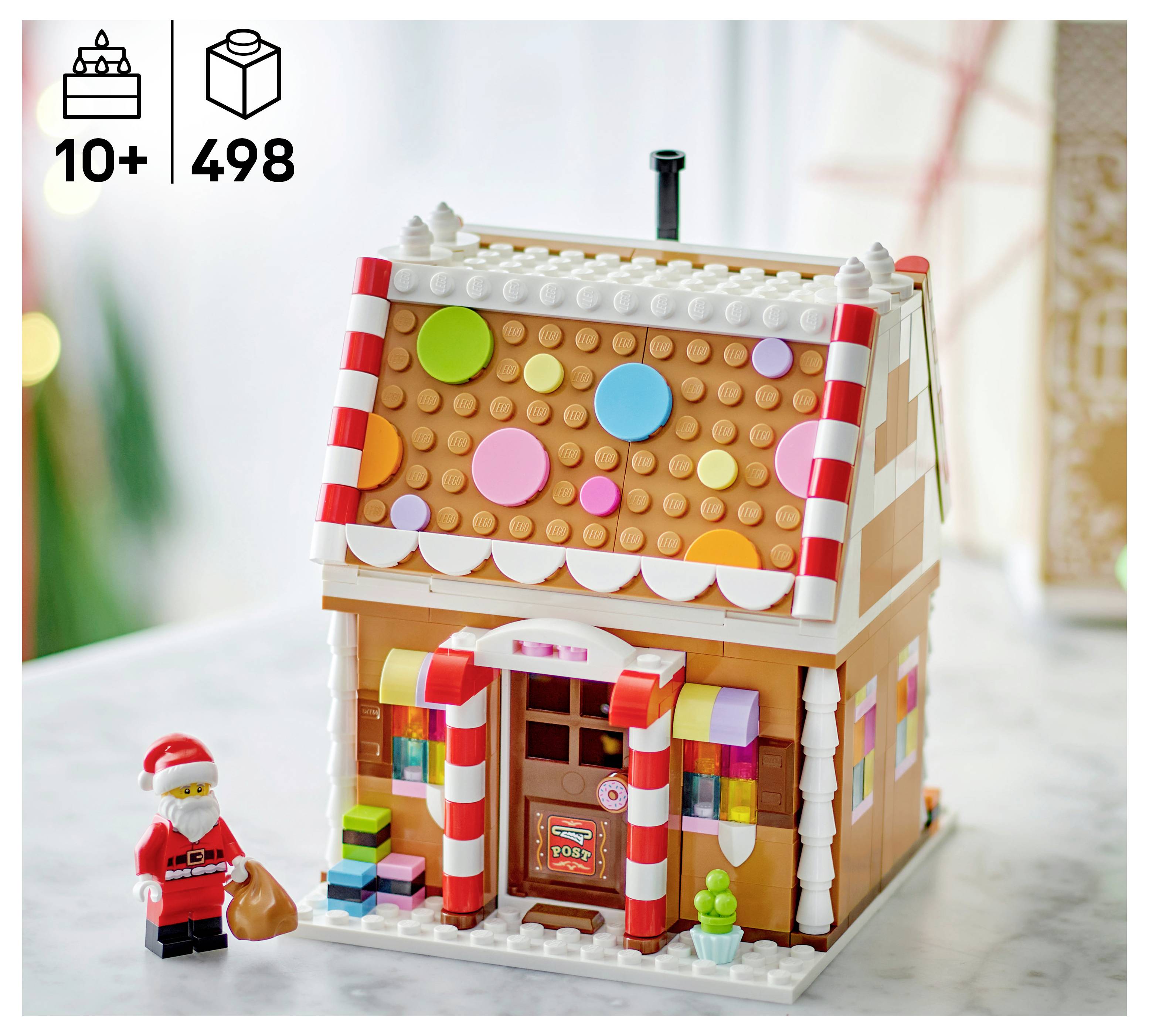 LEGO Lebkuchenhaus-Set im Lebkuchen-Stil mit Süßigkeitenverzierungen und Santa-Minifigur; ab 10 Jahren und 498 Teile abgebildet.