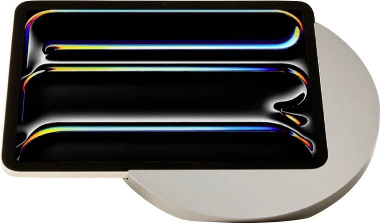 Preisgekröntes schwarzes rechteckiges Gerät mit glänzenden regenbogenfarbig beleuchteten Rillen, gezeigt auf einem runden Ständer; Abzeichen lesen „reddot winner 2025