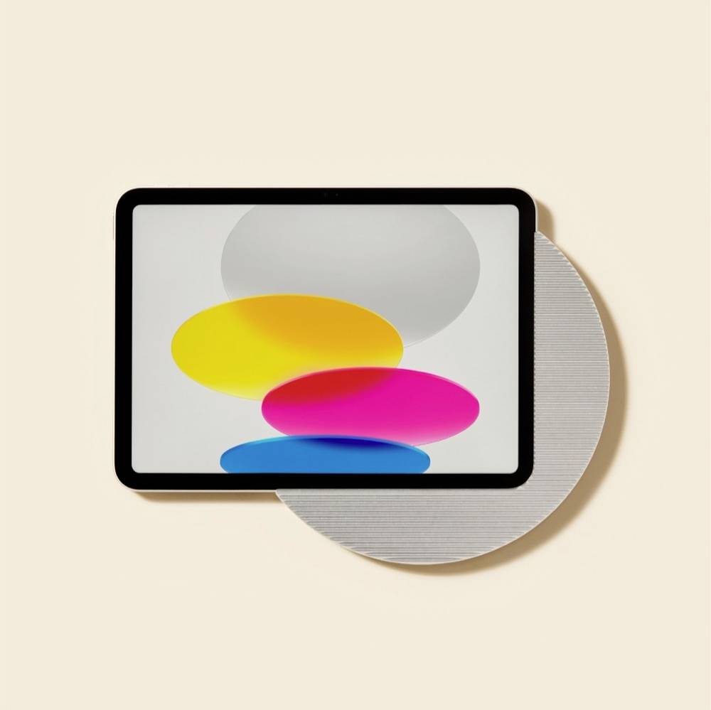 Abstrakte Tablet-Anzeige mit überlappenden gelben, rosa, blauen und grauen ovalen Formen auf hellem Hintergrund, die eine digitale Kunst- oder Designgrafik suggeriert.