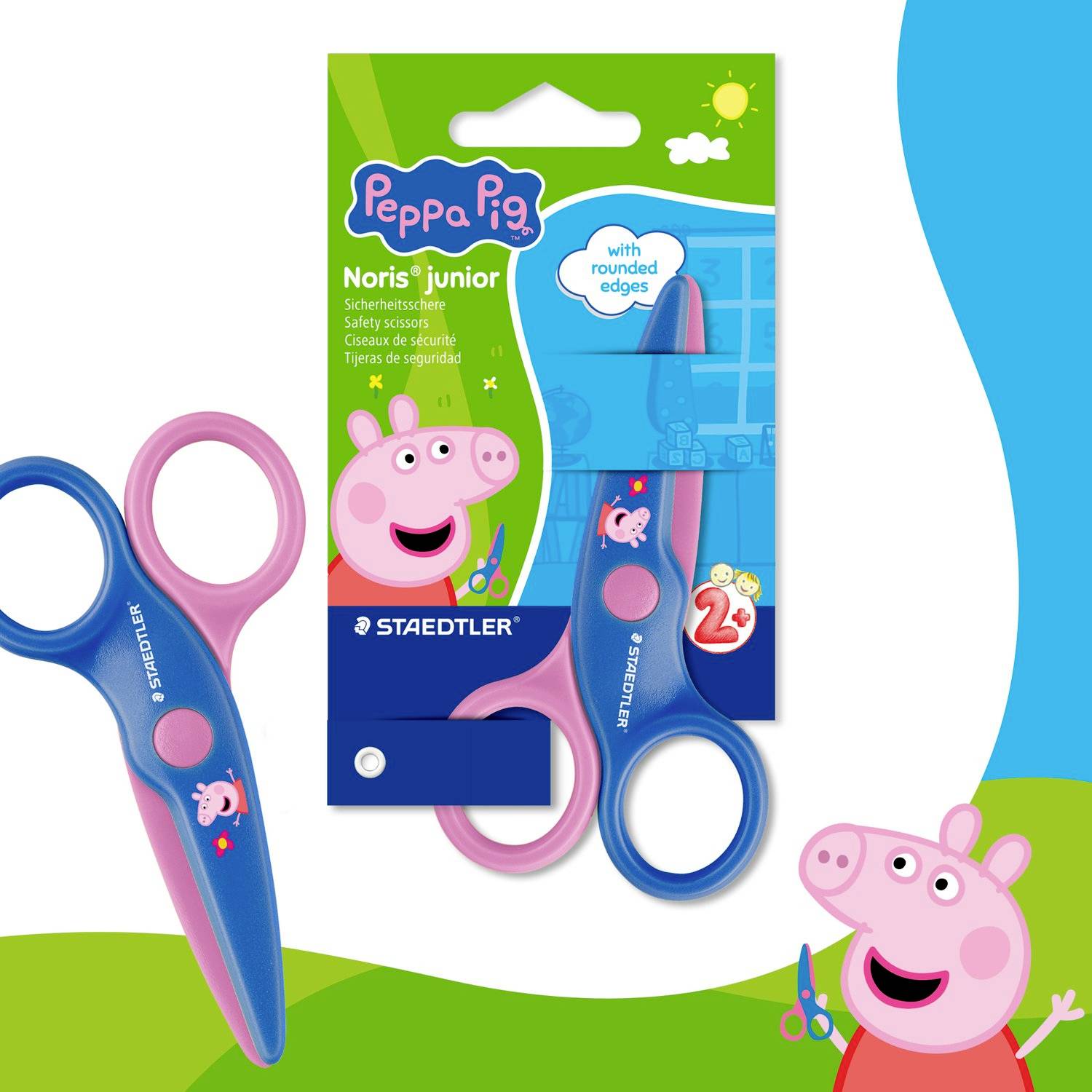 Peppa Pig Junior Sicherheitsschere Verpackung und zwei rosa-blaue kindsichere Scheren mit abgerundeten Kanten, gezeigt auf weißem und grünem Hintergrund.
