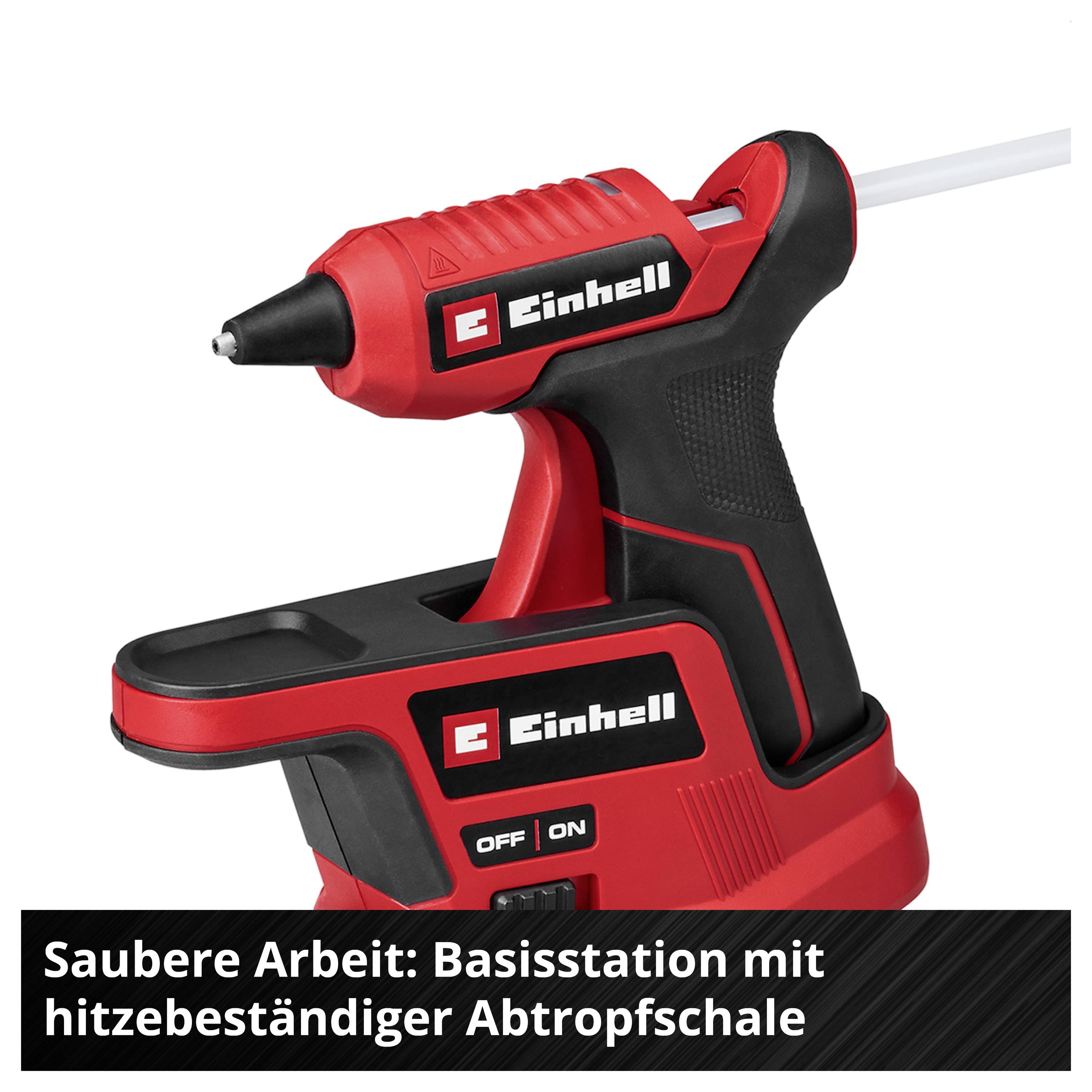 Rote Einhell-Heißklebepistole auf Ladestation mit Abtropfschale; Text: 'Saubere Arbeit: Basisstation mit hitzebeständiger Abtropfschale'.