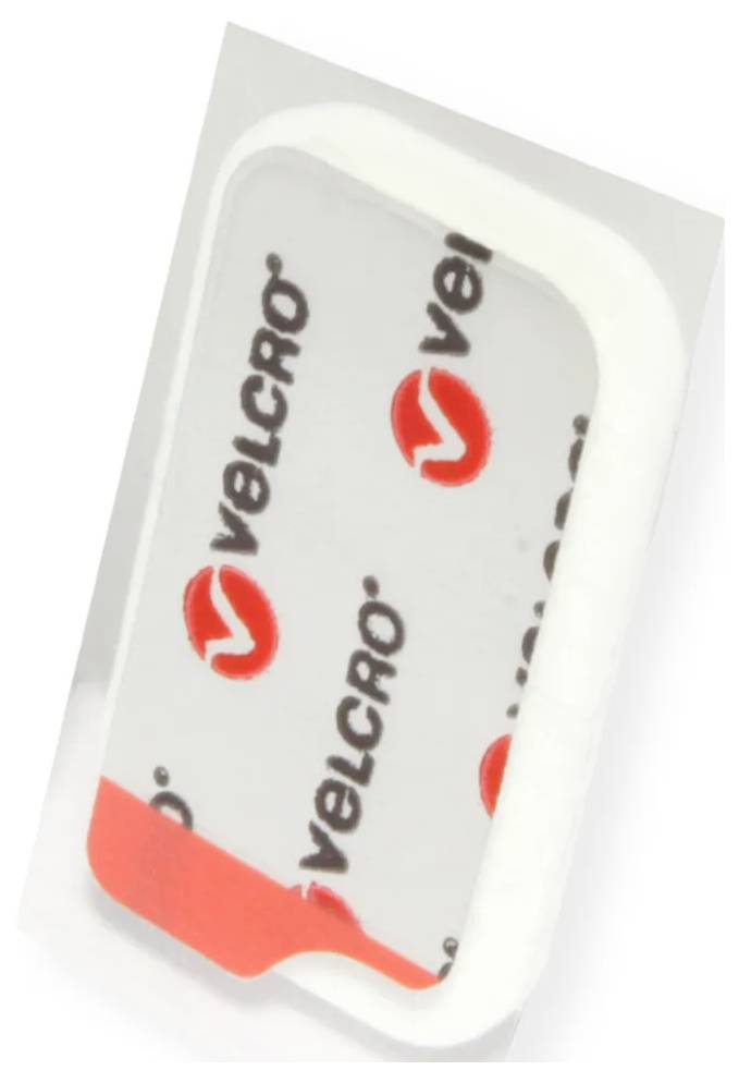 Nahaufnahme eines Klettverschluss-Klebestreifens in Kunststoffverpackung, diagonal gedreht, mit wiederholtem „VELCRO"-Branding und roten Logomarken.