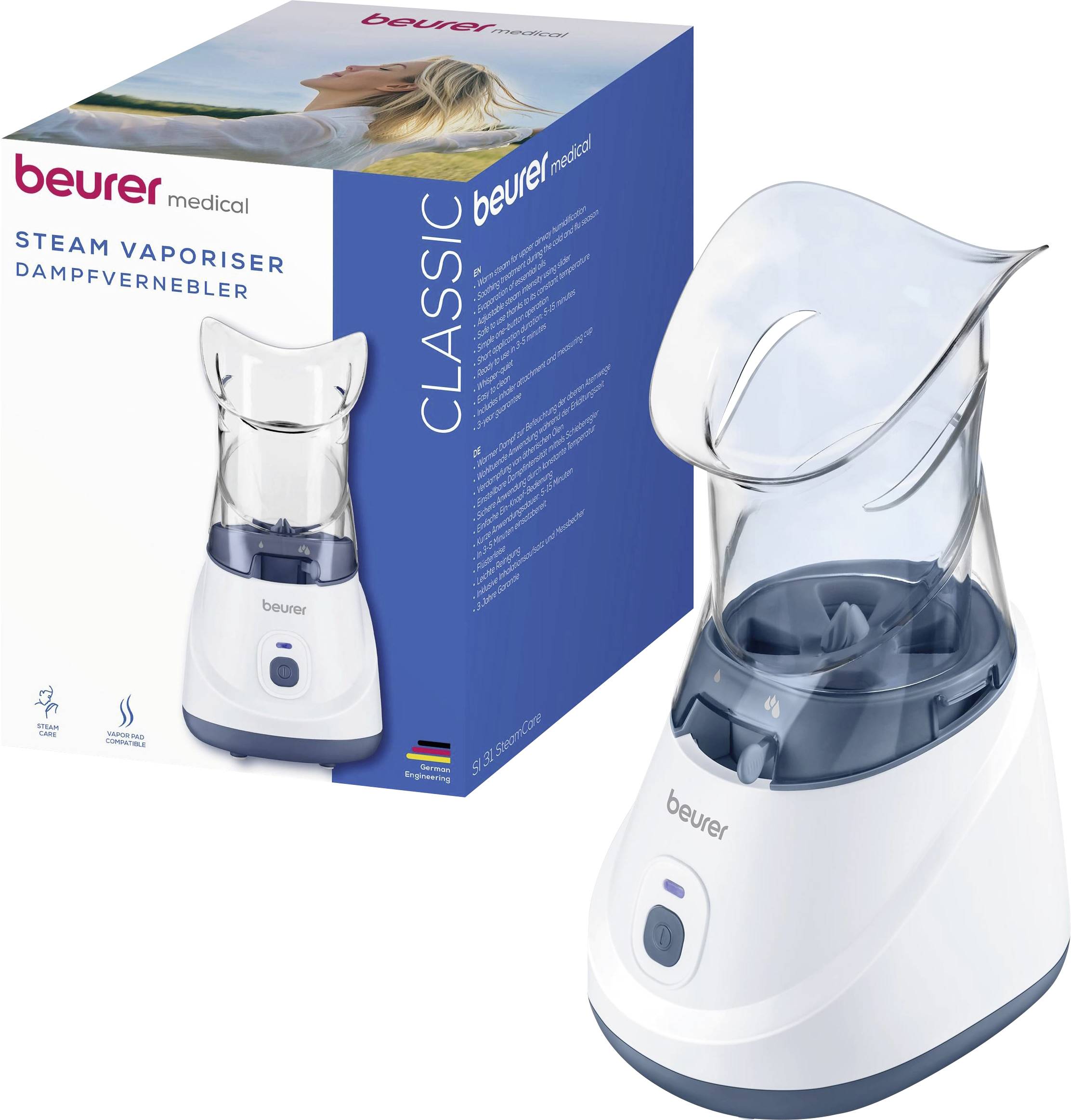Beurer Medical Dampfverdampfer, abgebildet mit seiner blau-weißen Produktverpackung und dem zusammengebauten Gerät mit einer transparenten Dampfmaske.