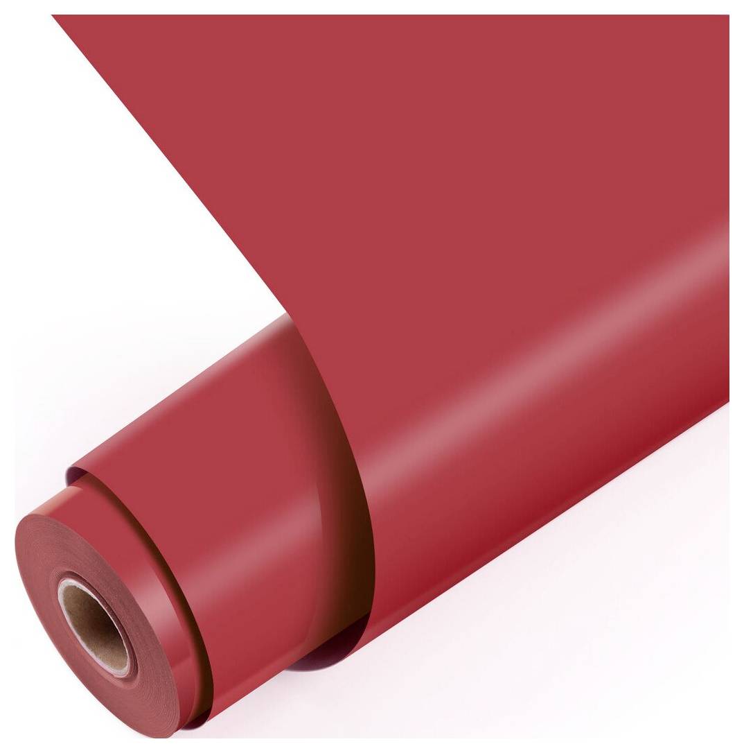 Gerolltes rotes Papier oder Vinylblatt mit Pappkern, teilweise auf weißem Hintergrund abgerollt.