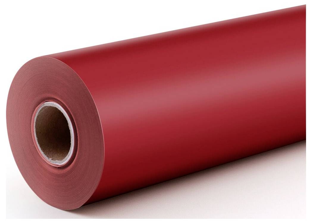 Große Rolle aus rotem Papier- oder Vinyliermaterial in Nahaufnahme, die den hohlen Pappkern und die glänzende Oberfläche zeigt.