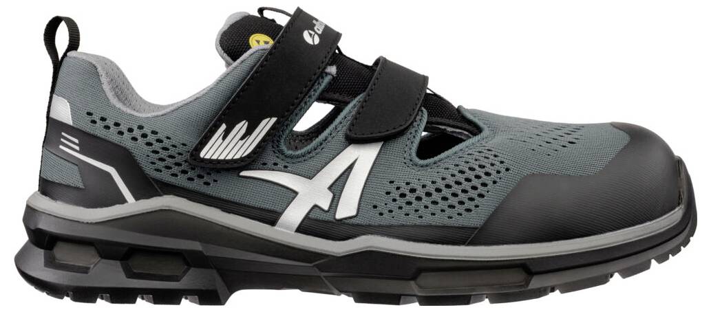 Grauer und schwarzer Athletic-Arbeitschuh mit Klettband-Verschlüssen und robustem Profil, in Seitenansicht auf weißem Hintergrund