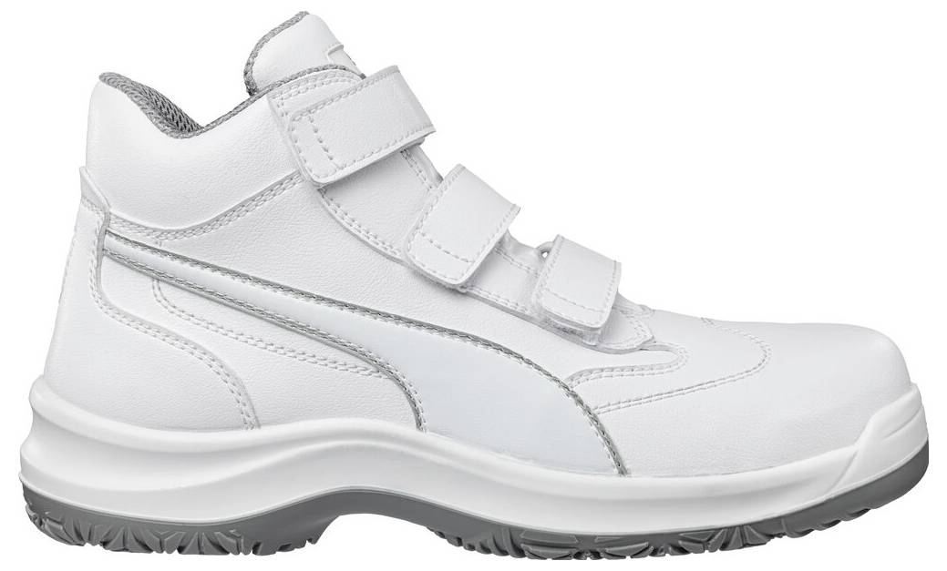 Weißer niedriger Arbeits-Sneaker mit Klettverschlussriemen und dicker schwarzer Sohle, in Seitenansicht auf neutralem Hintergrund gezeigt.