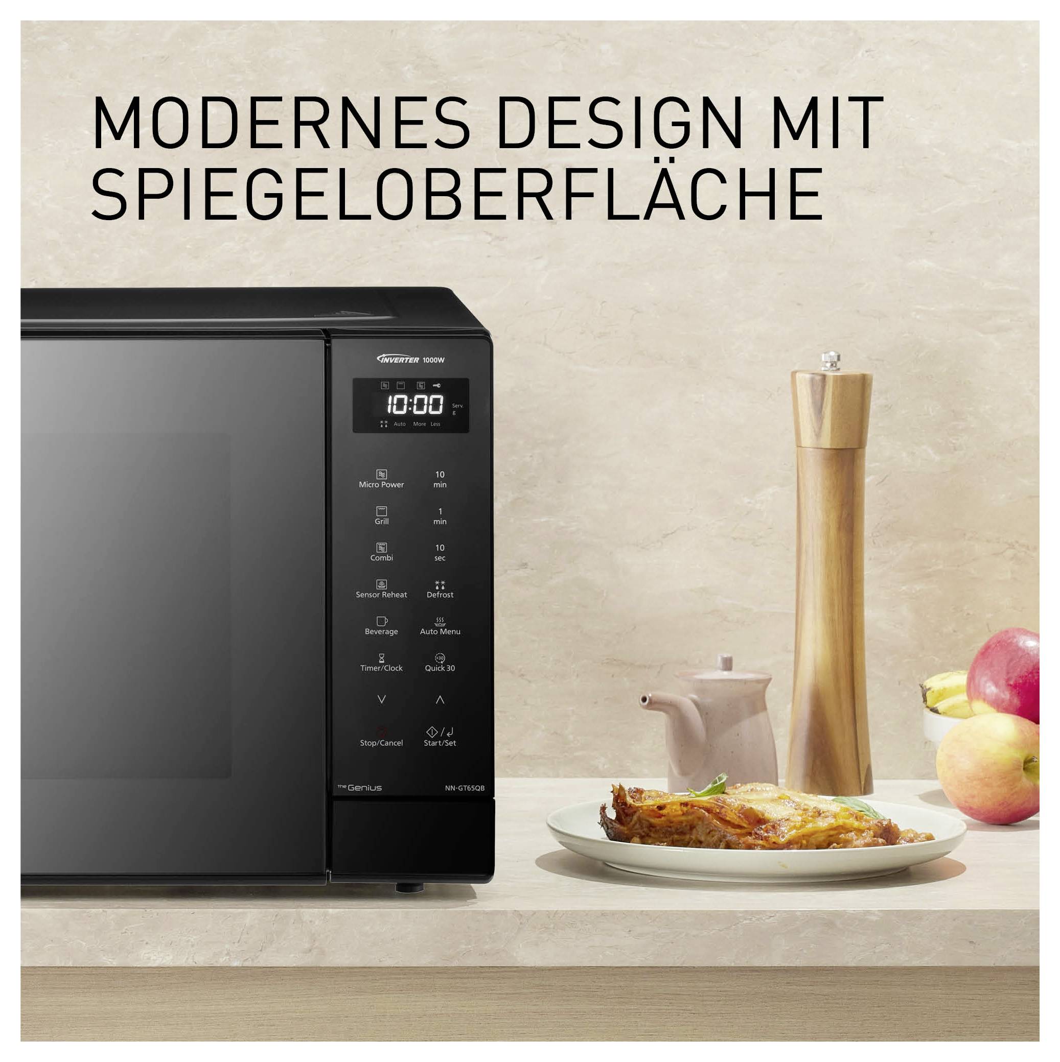 Mikrowelle mit Spiegeloberfläche neben gedecktem Tisch; Text: 'MODERNES DESIGN MIT SPIEGELOBERFLÄCHE'.