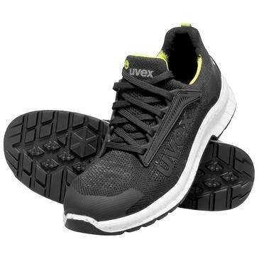 Schwarzer Uvex Sportarbeitschuh mit weißer Sohle und gelben Akzenten, dargestellt mit profilierter Laufsohle für Griffigkeit.