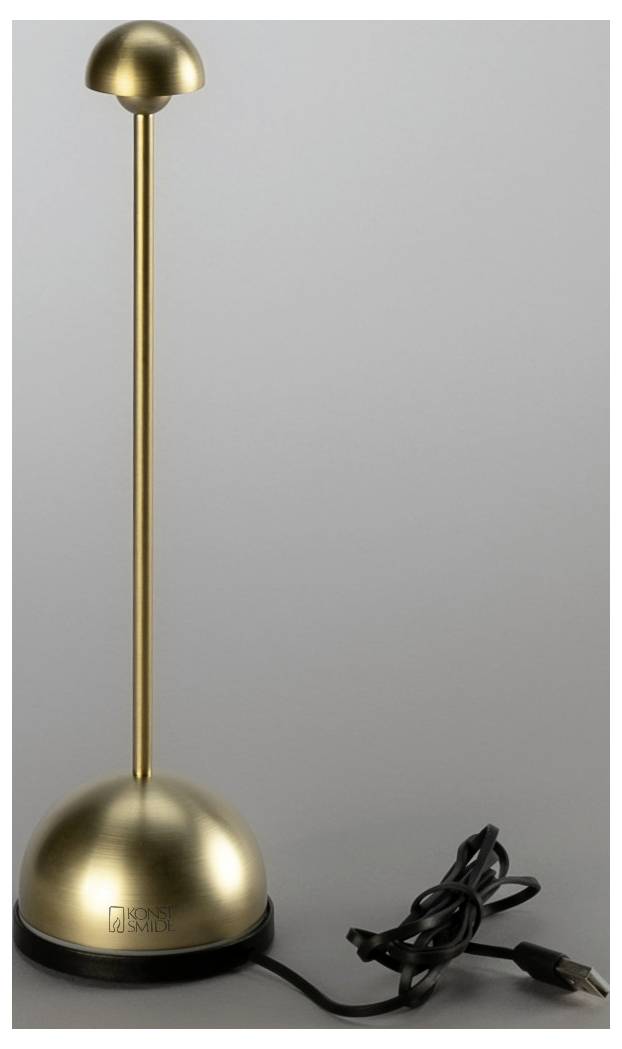 Goldene Tischleuchte mit Kuppelbasis und Schirm, dargestellt mit angeschlossenem schwarzem Stromkabel vor einfachem grauem Hintergrund.