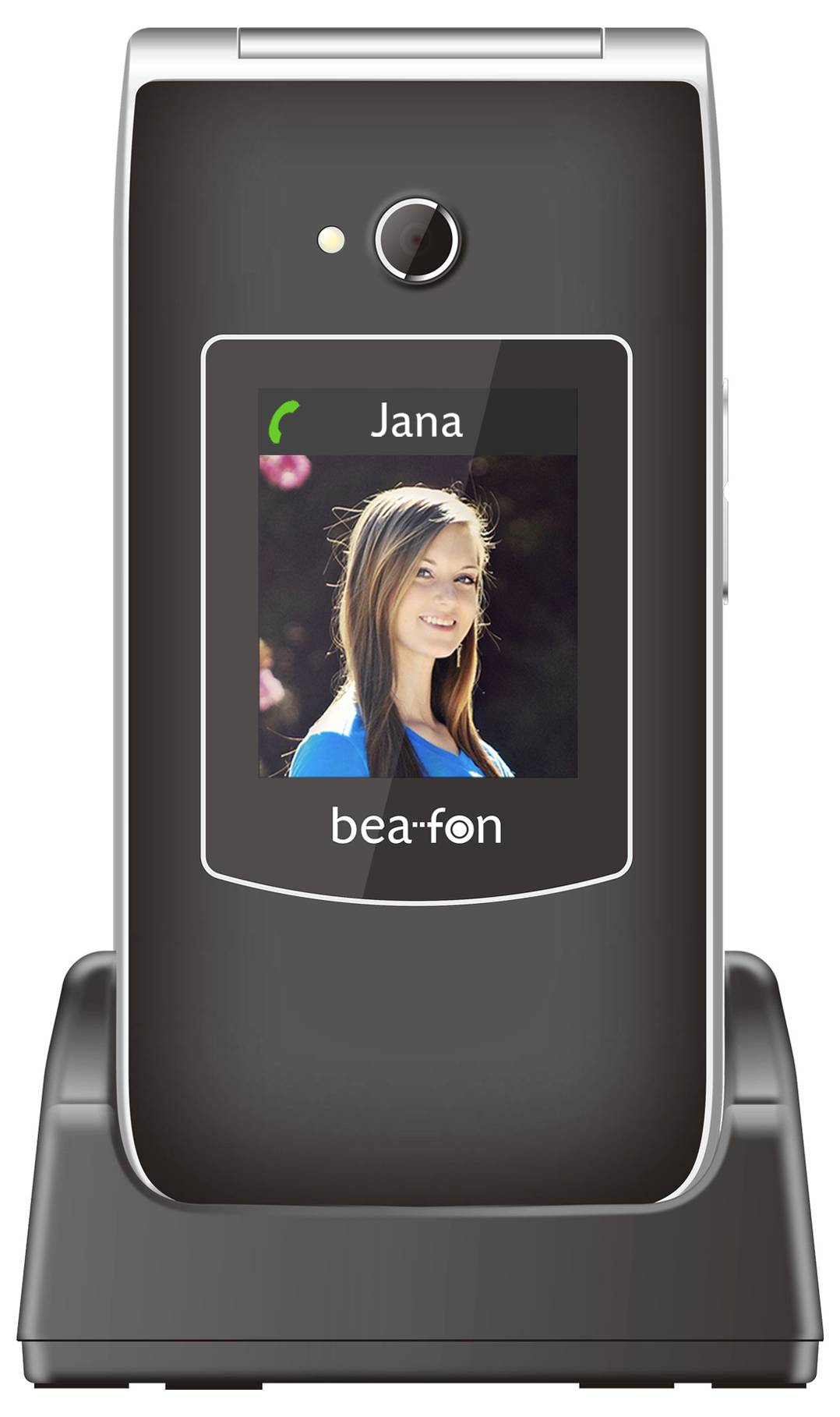 Zugeklapptes Klapphandy auf einer Ladestation, auf dem ein Anruferbildschirm mit dem Kontaktnamen "Jana" und einem Frauenfoto angezeigt wird.