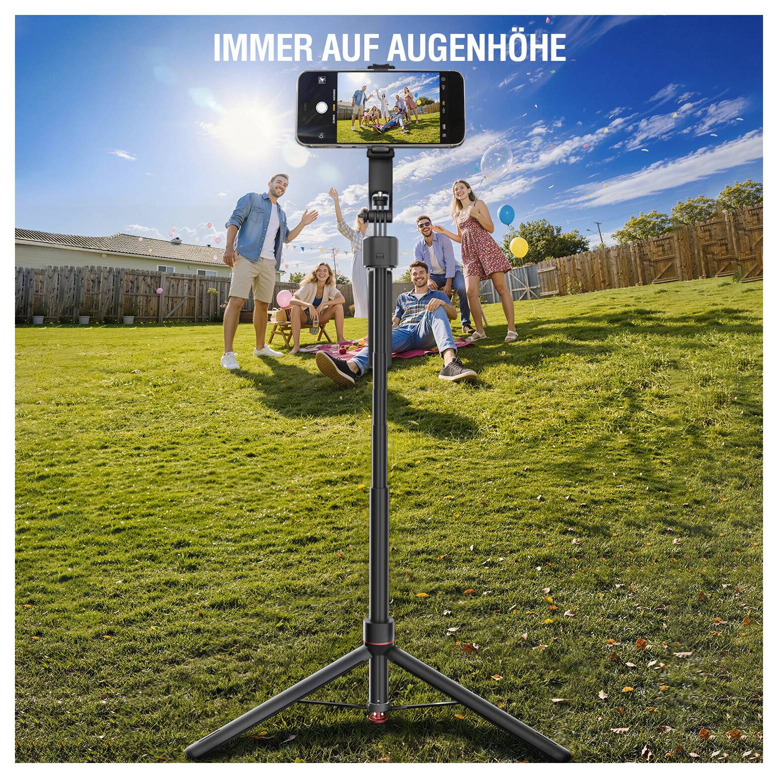 Auf einem Stativ montiertes Telefon filmt eine Gruppe von Freunden in einem sonnigen Hinterhof, mit dem Text „IMMER AUF AUGENHÖHE" oben.