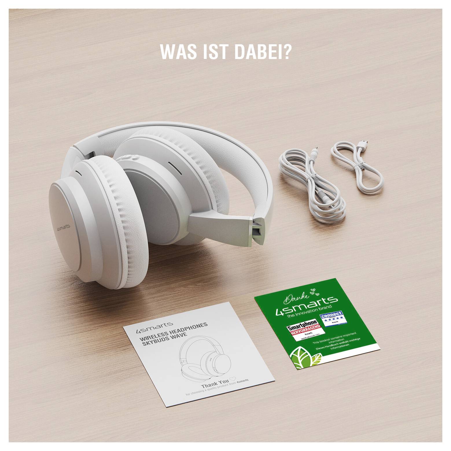 Weiße kabellose Over-Ear-Kopfhörer mit zwei Ladekabeln und Produktkarten auf einem Tisch; der Text sagt „WAS IST DABEI?" und „LSmart"
