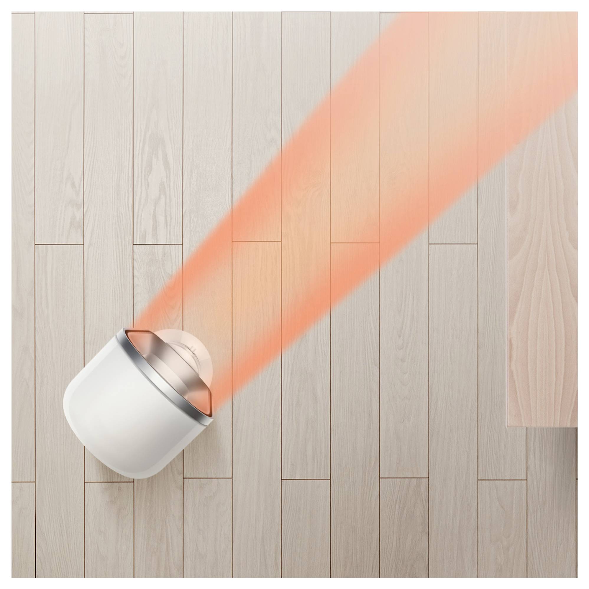 Weißes Smart-Home-Gerät auf Holzboden, das einen hellen roten Strahl diagonal über den Raum projiziert