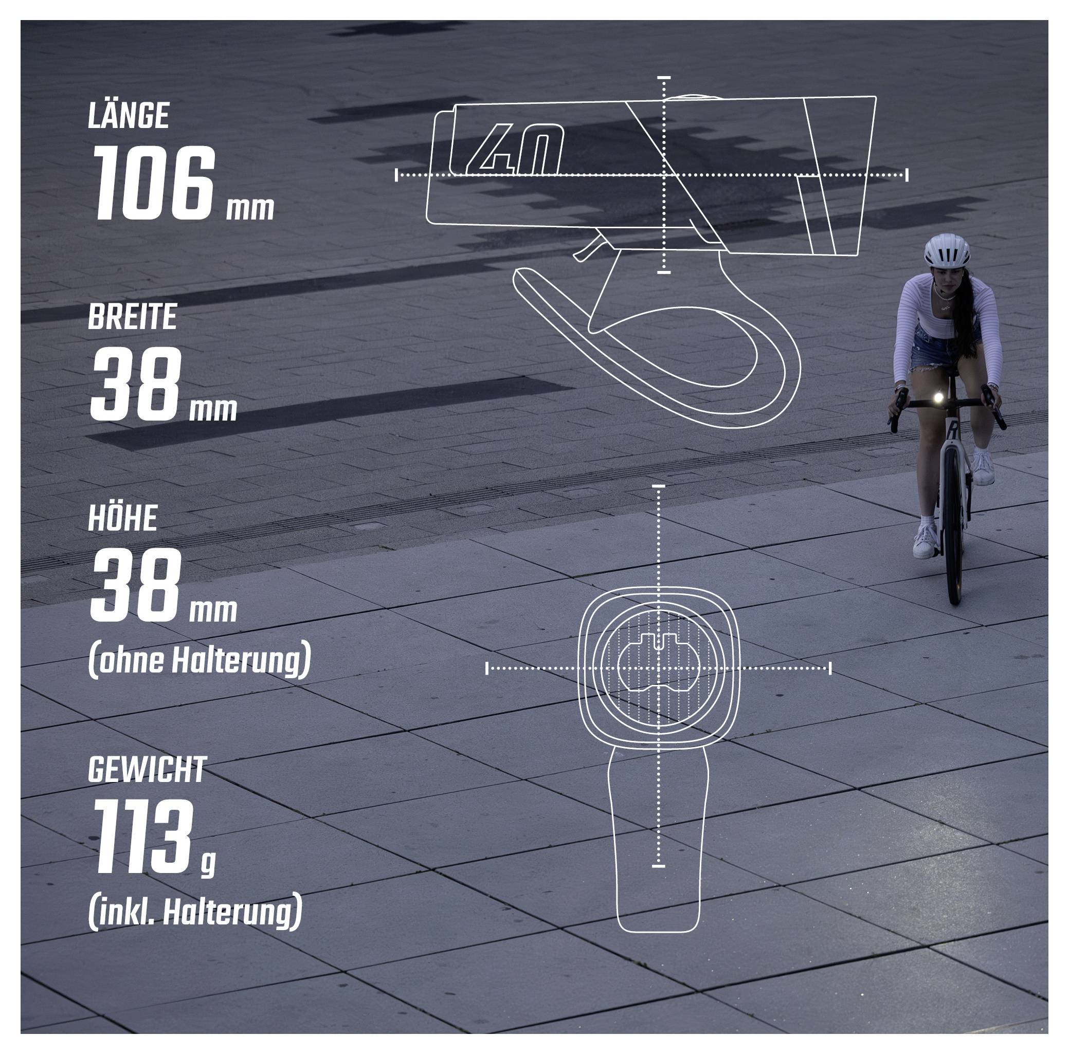 Grafik mit Produktmaßen eines Fahrradteils: Länge 106 mm, Breite 38 mm, Höhe 38 mm ohne Halterung, Gewicht 113 g inklusive Halterung; Radfahrer im Hintergrund.