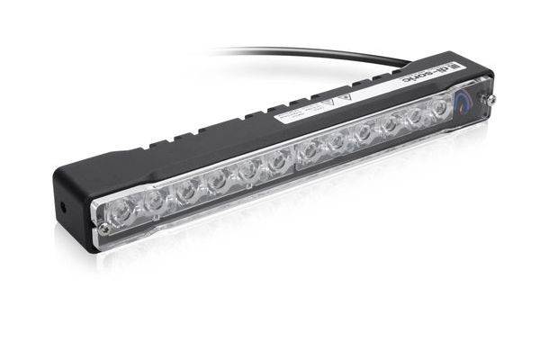 Schwarze rechteckige LED-Leuchtenleiste mit mehreren klaren Linsen und einem Stromkabel, dargestellt auf weißem Hintergrund.