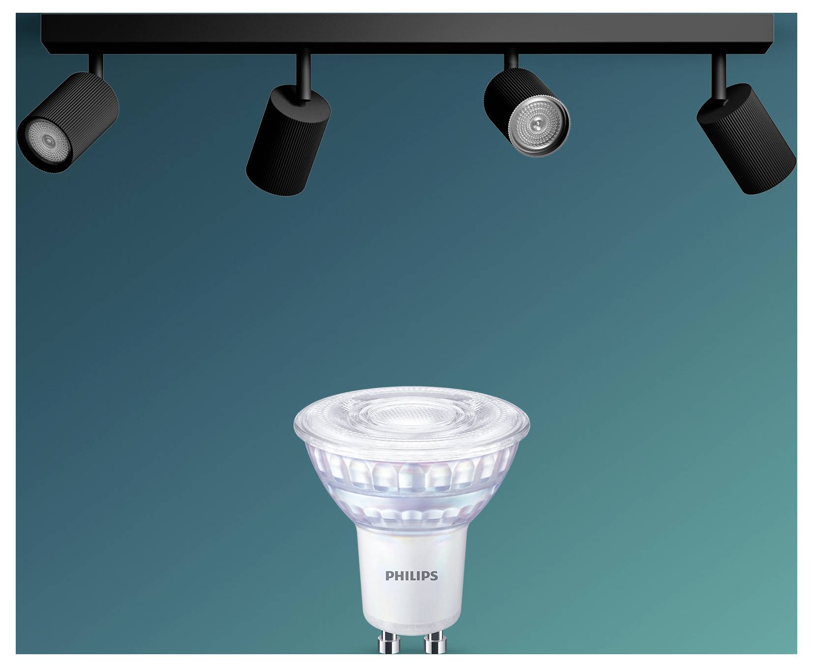 Philips LED-Spotlightbirne gezeigt unter vier Deckenflächenleuchten auf tealblauenem Hintergrund.