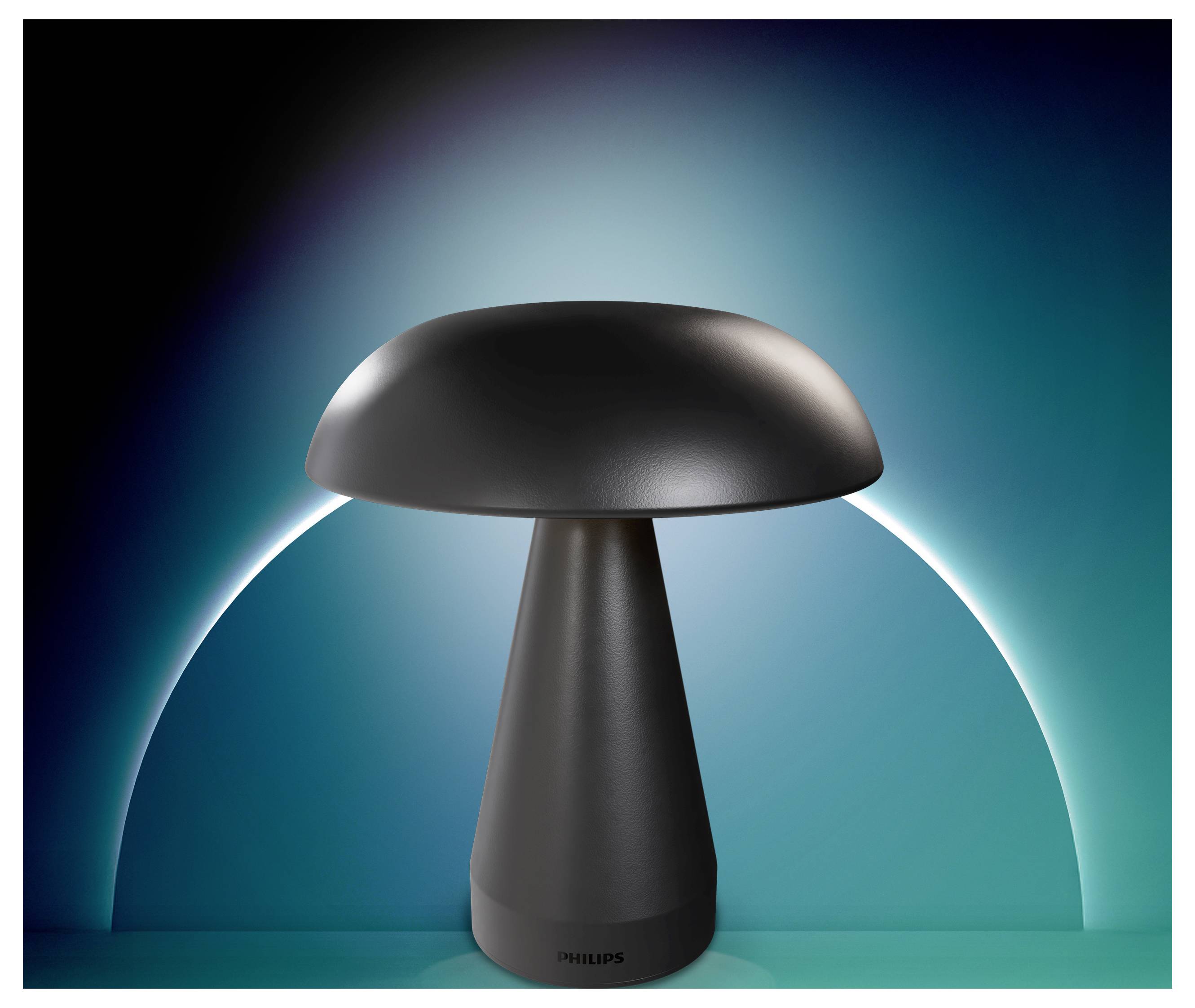 Eine moderne schwarze pilzförmige Lampe, zentriert vor einem blaugrünen leuchtenden Hintergrund mit einem weißen Bogen dahinter.