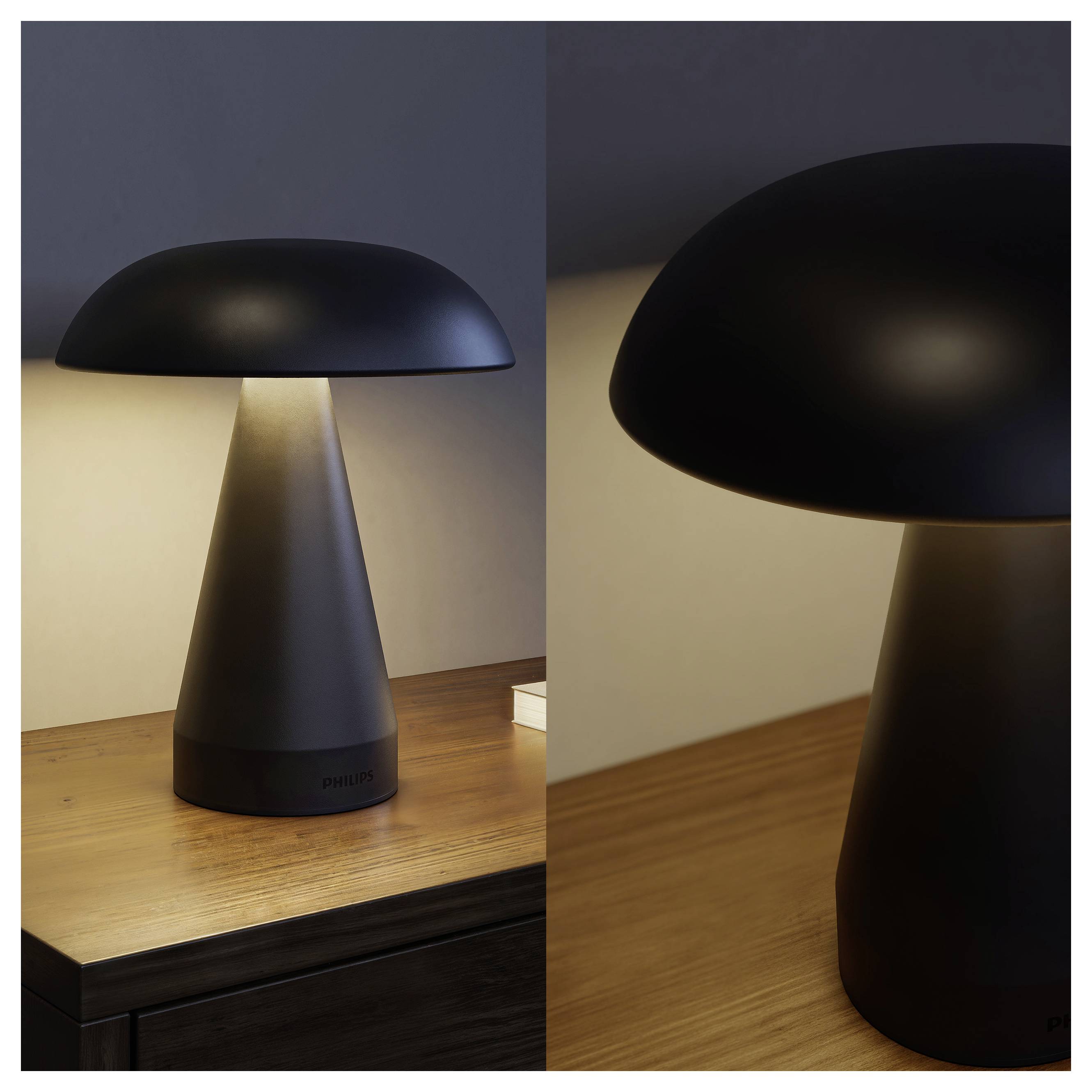 Schwarze pilzförmige Tischlampe auf einem Holzschreibtisch, vollständig und in Nahaufnahme dargestellt, mit einem warmen Glühen unter dem breiten Schirm.