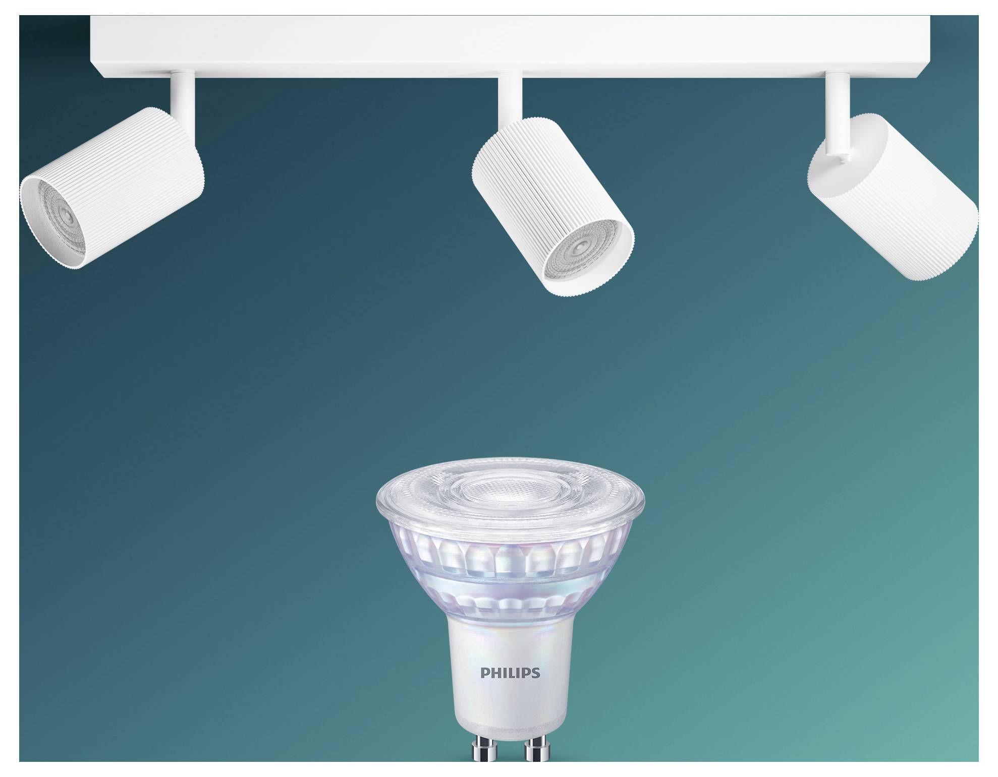 Spotlight-Schiene mit drei deckenmontiert Leuchten, die eine Philips LED-Spotlightbirne vor einem blaugrünen Hintergrund beleuchten.