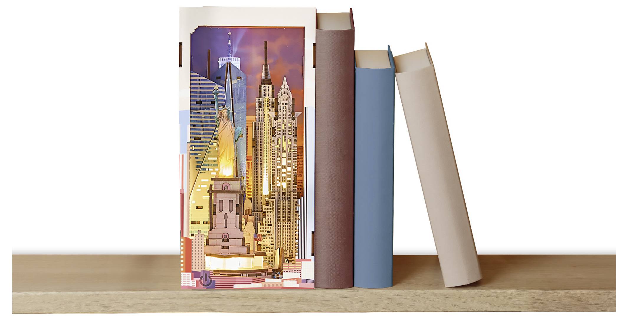 Drei aufrecht stehende Bücher auf einem Regal, wobei das vordere Buch eine farbenfrohe Illustration einer Stadtskyline zeigt.