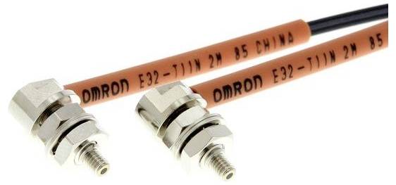 Zwei OMRON E32-T11N 2M B5 Faseroptik-Sensoren mit Gewinde-Metallverbindungen und orangefarbigen Kabeln auf weißem Hintergrund