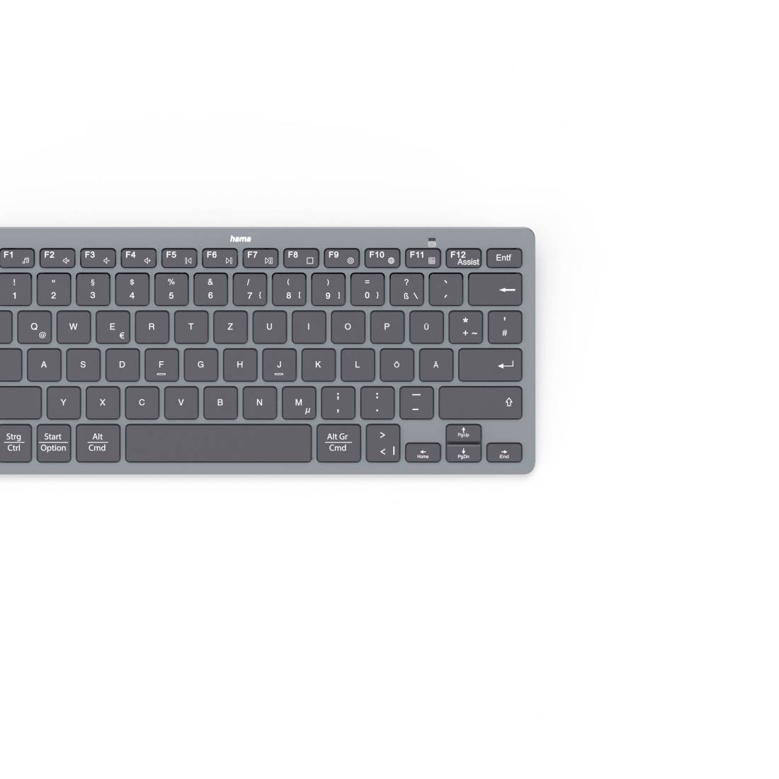 Kompakte graue kabellose Tastatur auf weißem Hintergrund, von oben betrachtet.