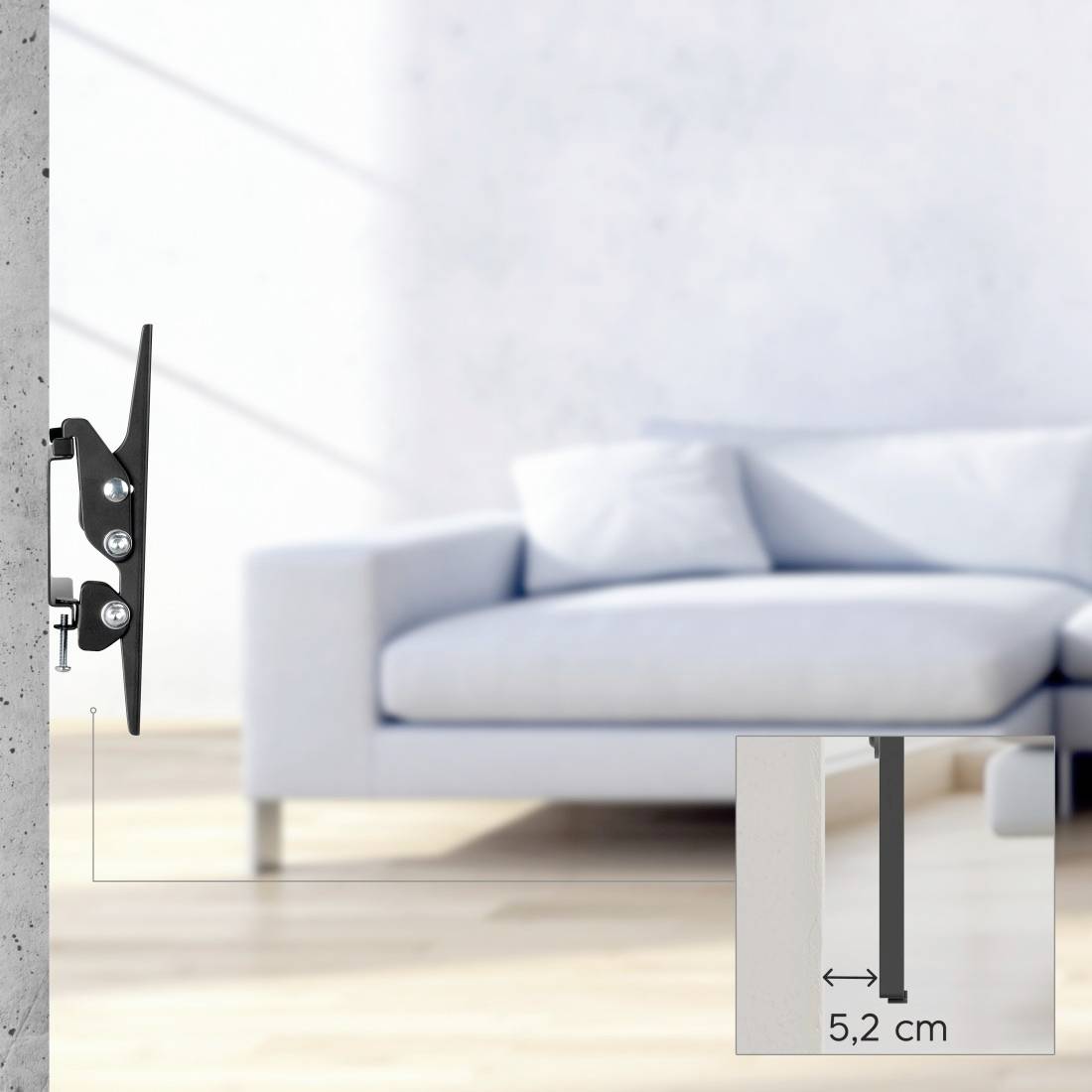 Wandmontierte Fernseh-Halterung in Seitenansicht neben einem unscharfen Sofa, mit eingefügter Messung, die die 5,2 cm Tiefe der Halterung anzeigt.
