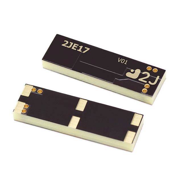 Zwei kleine rechteckige elektronische Komponenten, gezeigt in Draufsicht und Untersicht, mit schwarzen Oberflächen, goldenen Kontakten und Beschriftungen '2JE17' und 'V01'.
