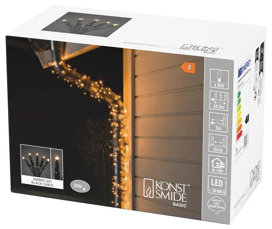 Produktbox für Konstsmide Basic Bernstein-LED-Lichterkette auf schwarzem Kabel, zeigt leuchtende Lichter, die um eine Dachkante gewickelt sind; Verpackung hebt 300 LEDs und Außenverwendung hervor.