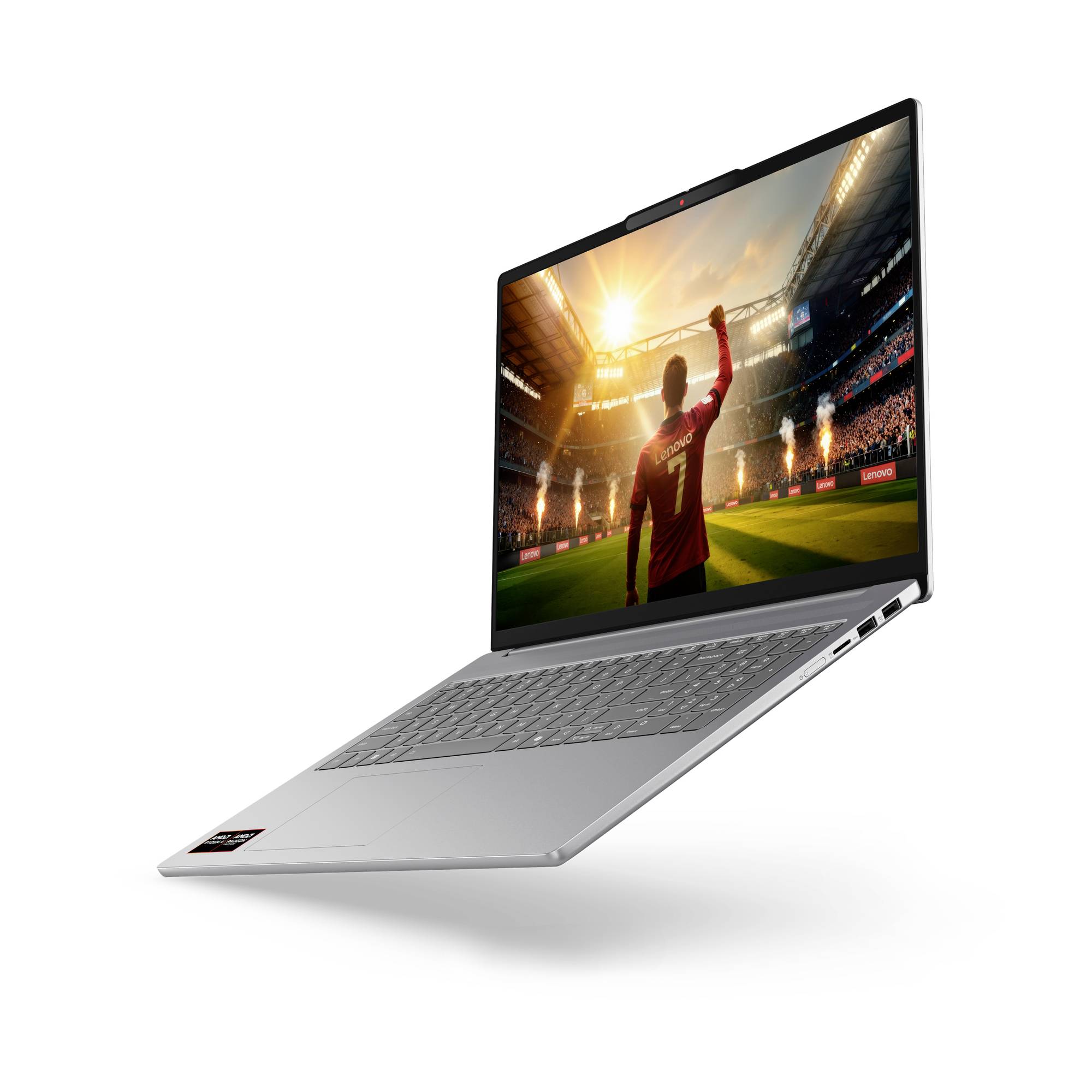 Silberner Laptop, auf dem ein Fußballspieler im Stadion zu sehen ist, wobei der Spieler seinen Arm unter hellen Lichtern hebt.