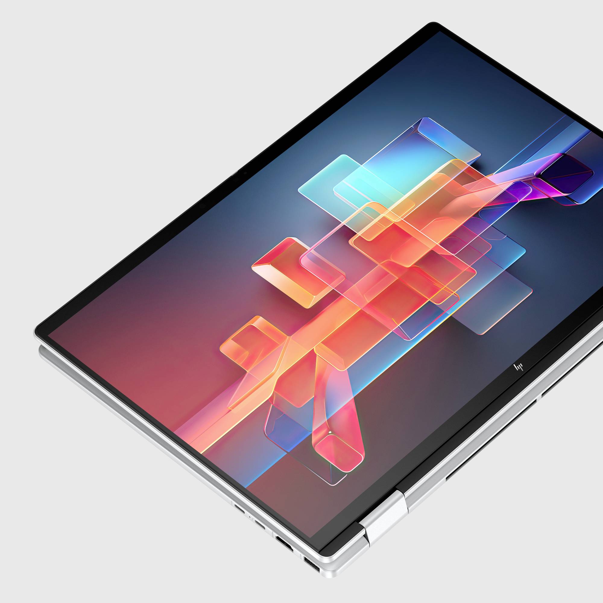 Ein aufgeklappter 2-in-1-Laptop wird im Tablet-Modus angezeigt, mit einem bunten abstrakten geometrischen Hintergrundbild auf dem Bildschirm.