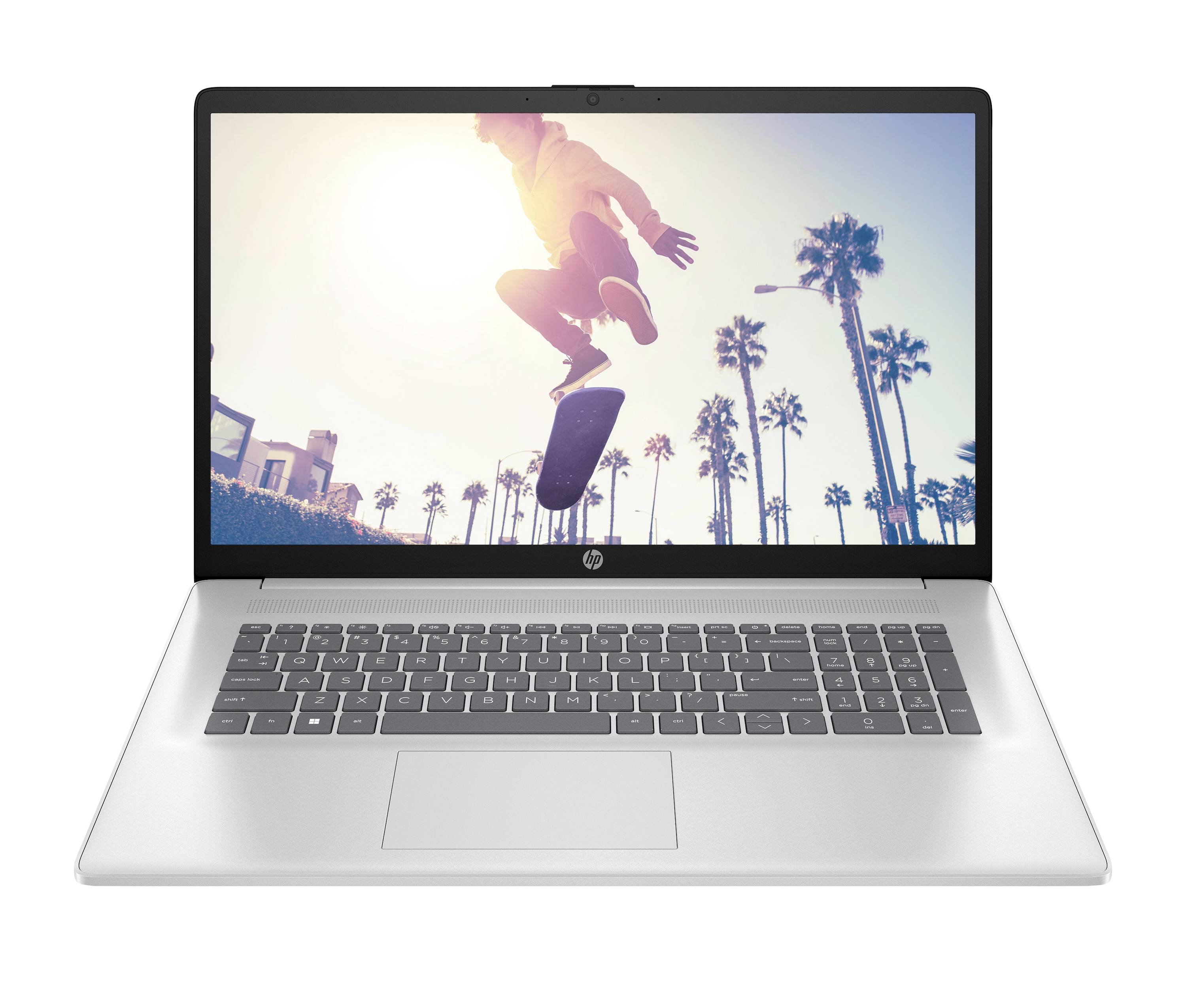 Offener Laptop, der einen Skateboarder im Sprung gegen einen sonnigen Palmenhintergrund zeigt.