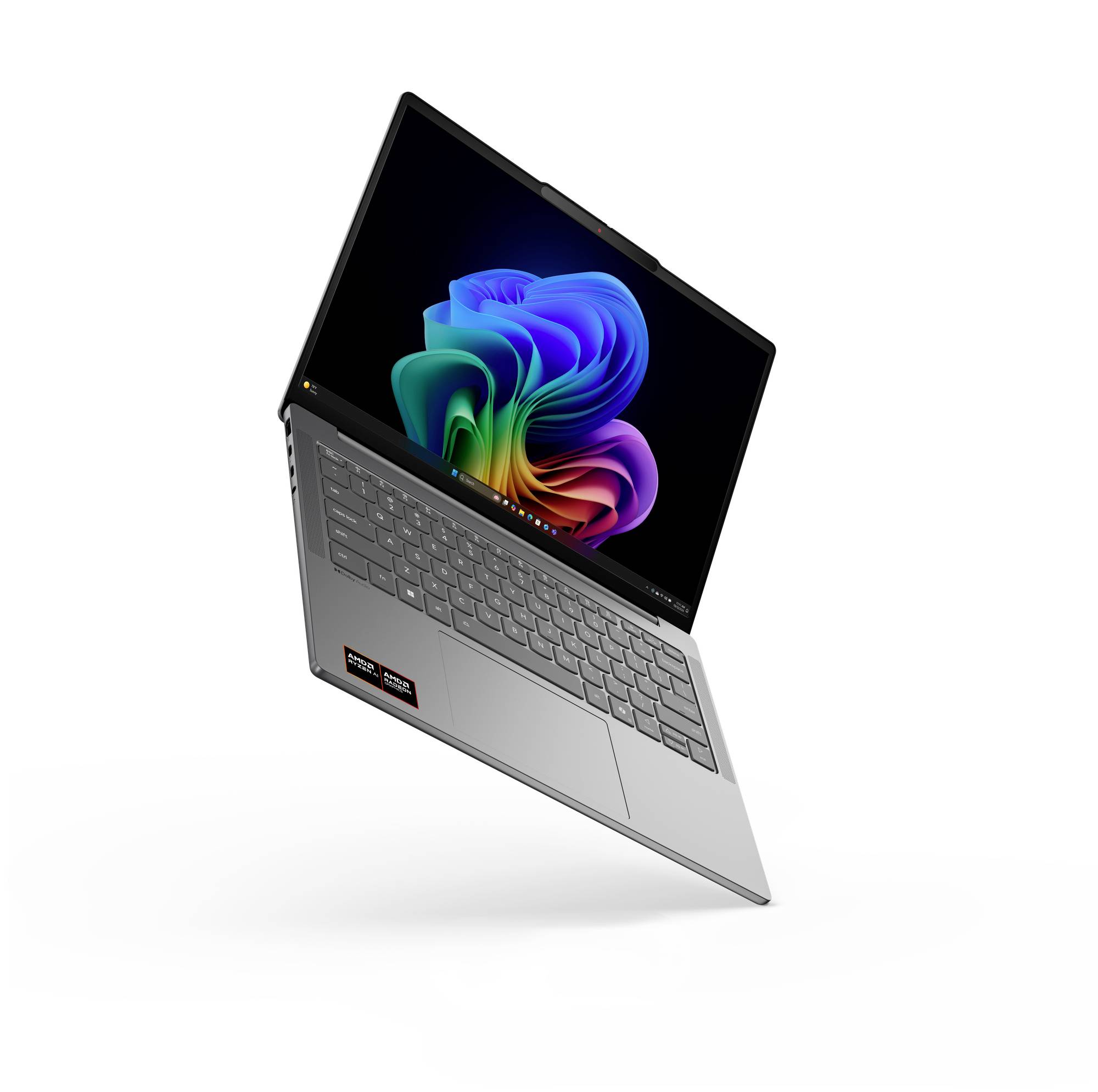 Silberner Laptop, der in einem Winkel geöffnet ist, mit einem farbenfrohen abstrakten Hintergrundbild auf dem Bildschirm und einer hintergrundbeleuchteten Tastatur, die sichtbar ist.