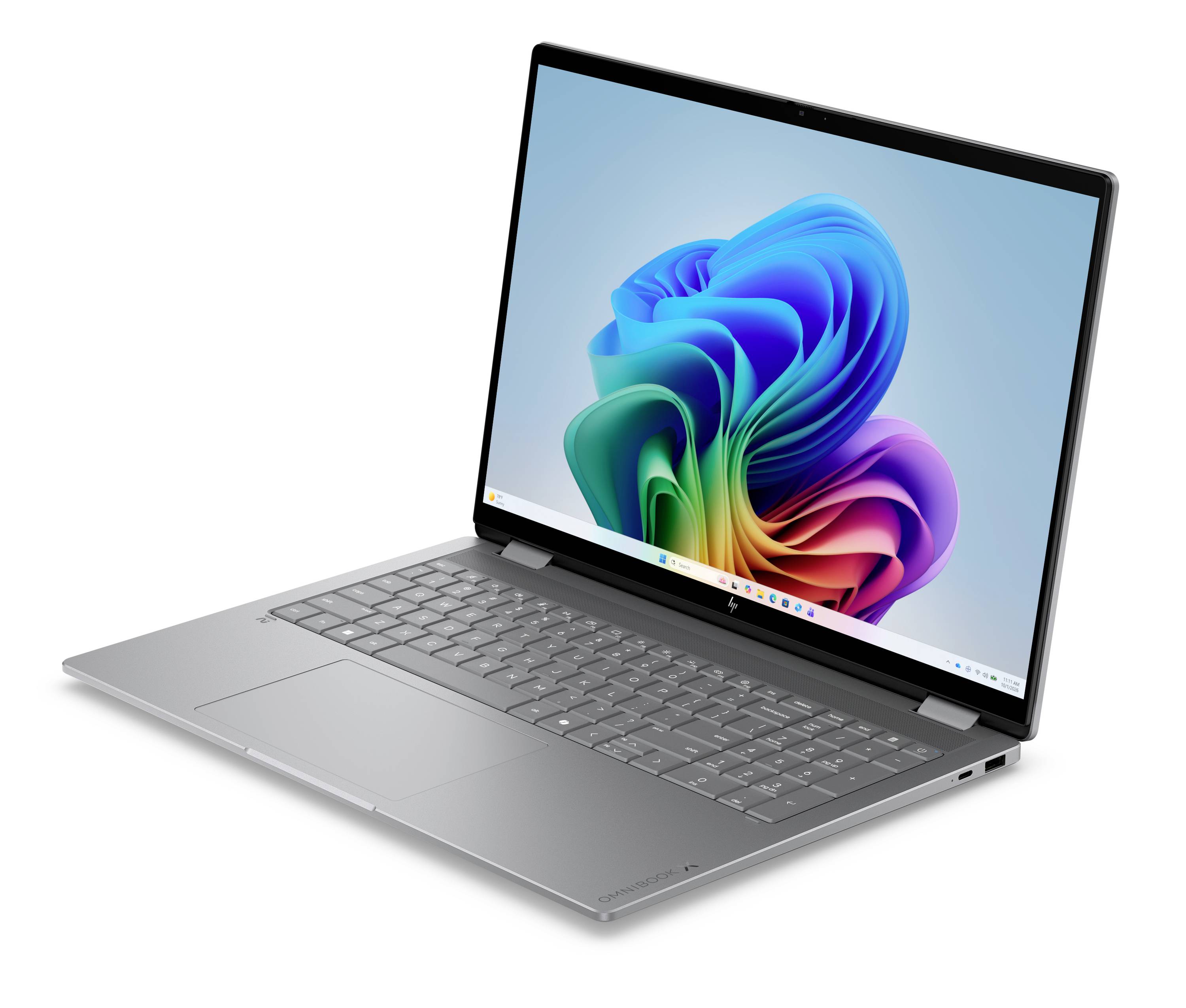 Silberner Laptop in einem Winkel geöffnet, zeigt ein farbenfrohe abstrakte Windows-artige Hintergrund auf dem Bildschirm.