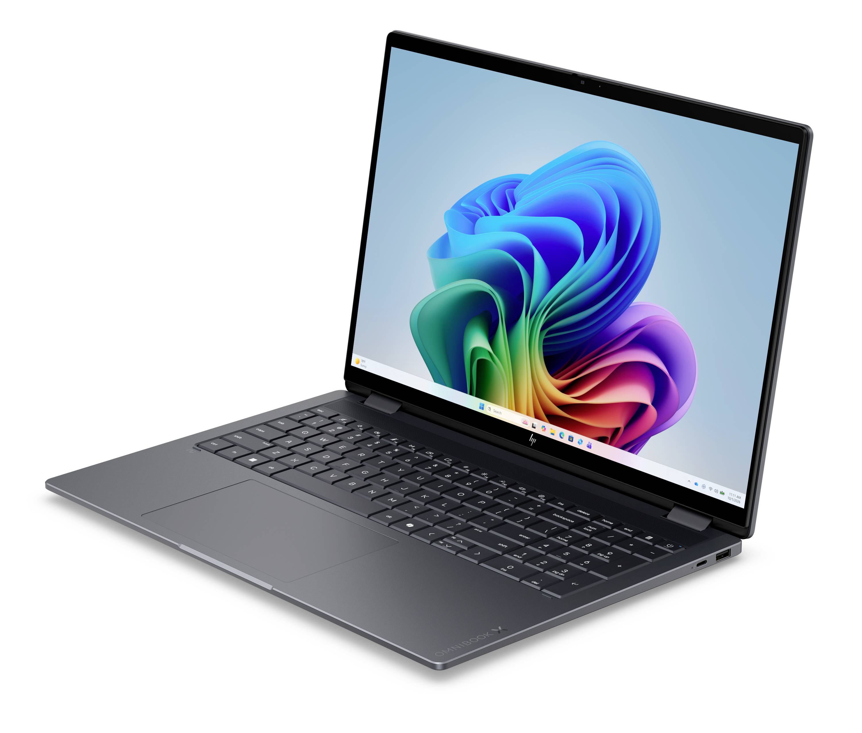 Ein schlanker grauer Laptop, der in einem Winkel geöffnet ist und zeigt ein farbenfrohe abstrakte Hintergrundbild auf dem Bildschirm.