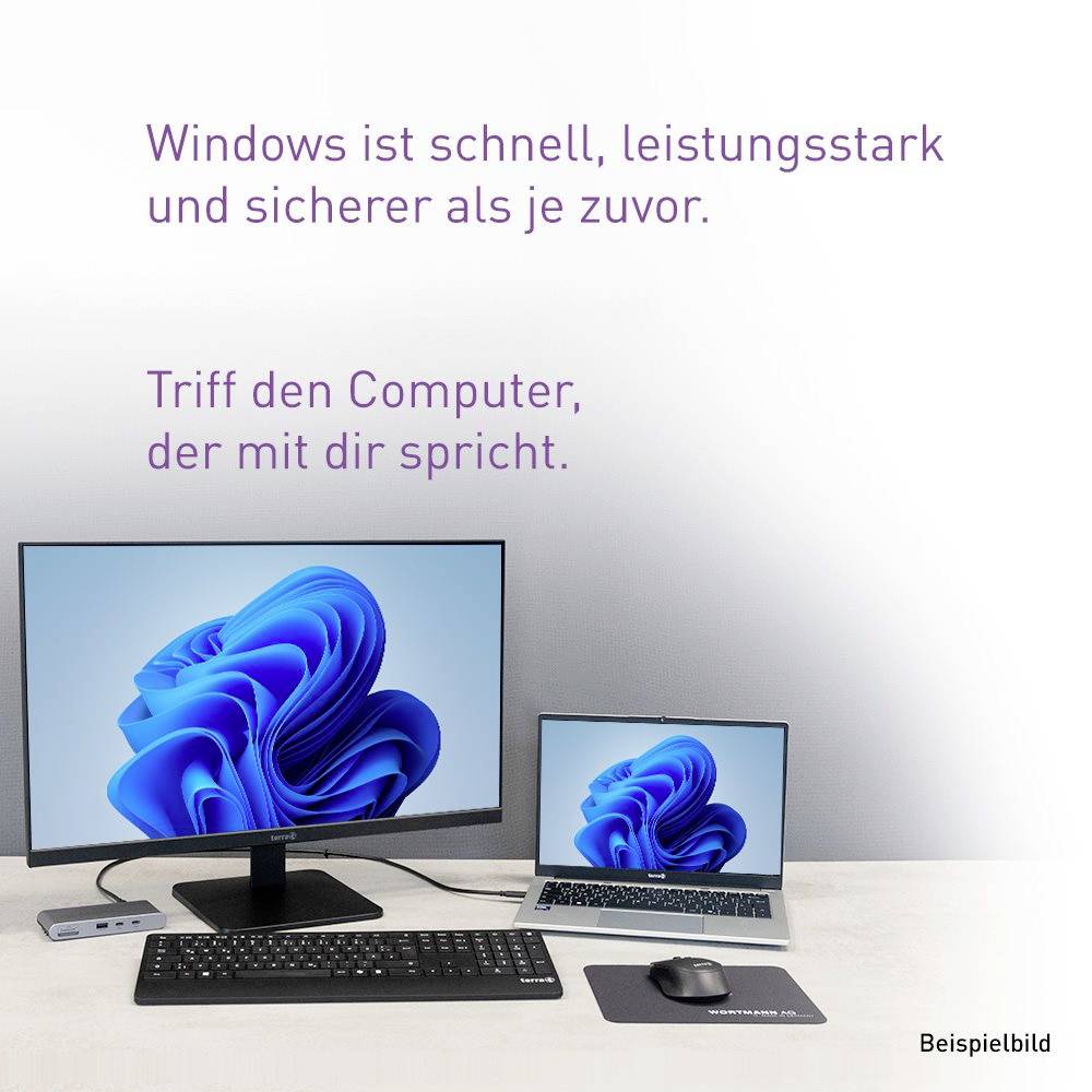Anzeige zeigt eine Windows-Desktop-Einrichtung mit Monitor, Laptop, Tastatur und Maus; deutscher Text sagt, dass Windows schneller, leistungsstärker und sicherer ist, und „Treffen Sie den Computer, der mit Ihnen spricht."