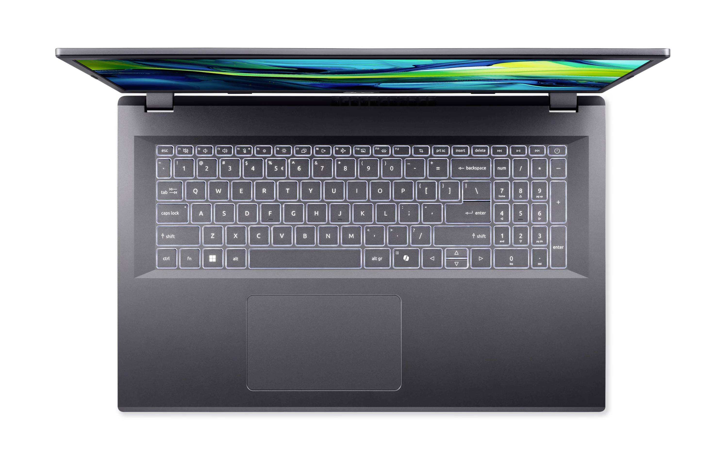 Draufsicht auf einen offenen schwarzen Laptop, der die Tastatur und das Trackpad zeigt, mit einem farbigen Bildschirmglimmen, das oben an der Kante sichtbar ist.
