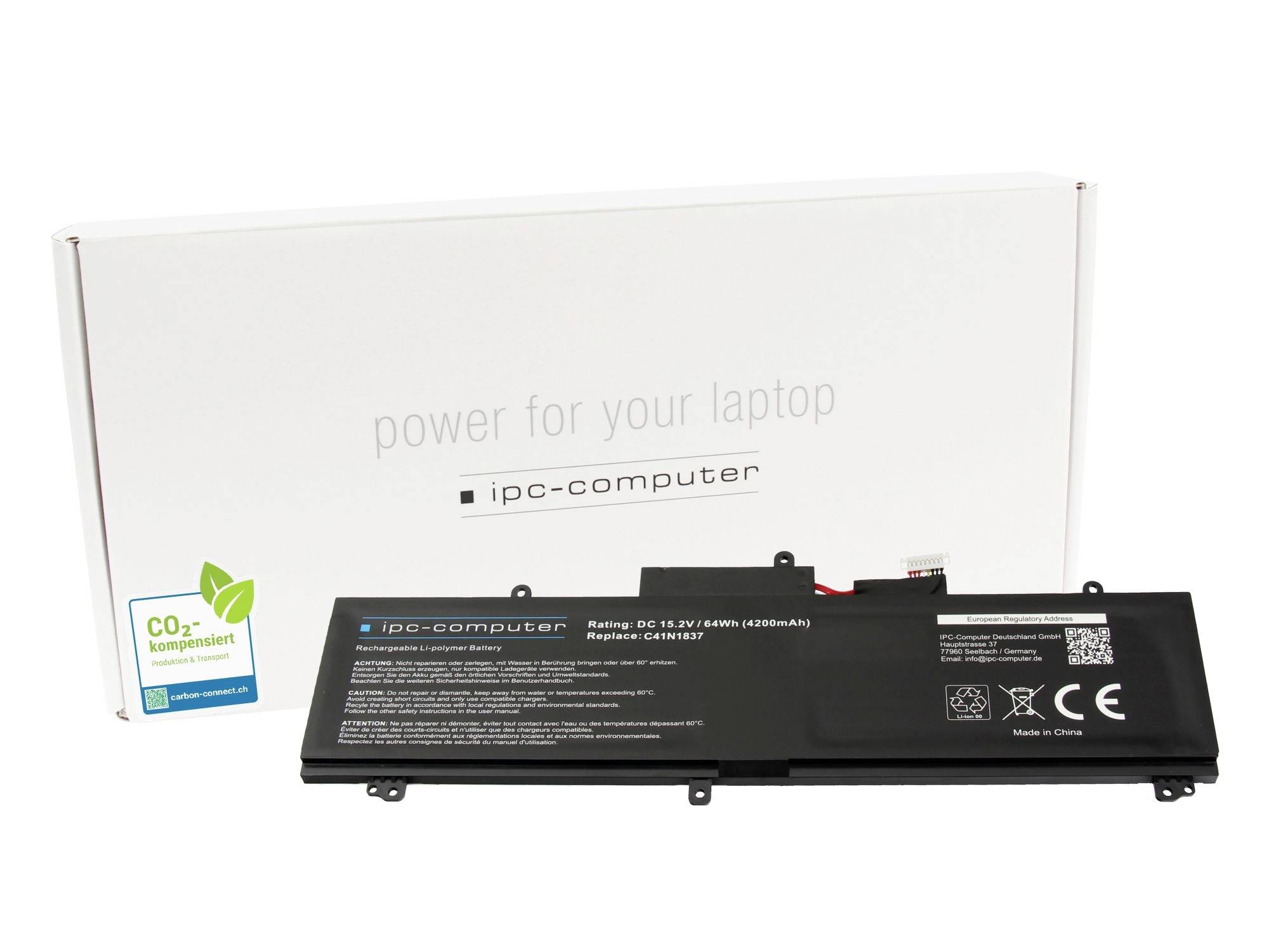 Laptop-Batterie vor einer weißen Schachtel mit der Aufschrift „Energie für Ihren Laptop