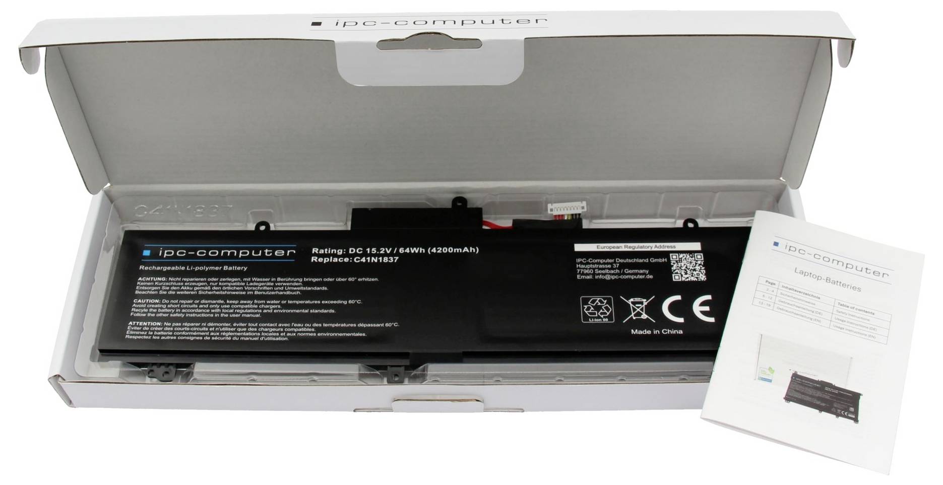 Geöffnete Schachtel mit einem schwarzen ipC-Computer-Akku und einer Bedienungsanleitung daneben.