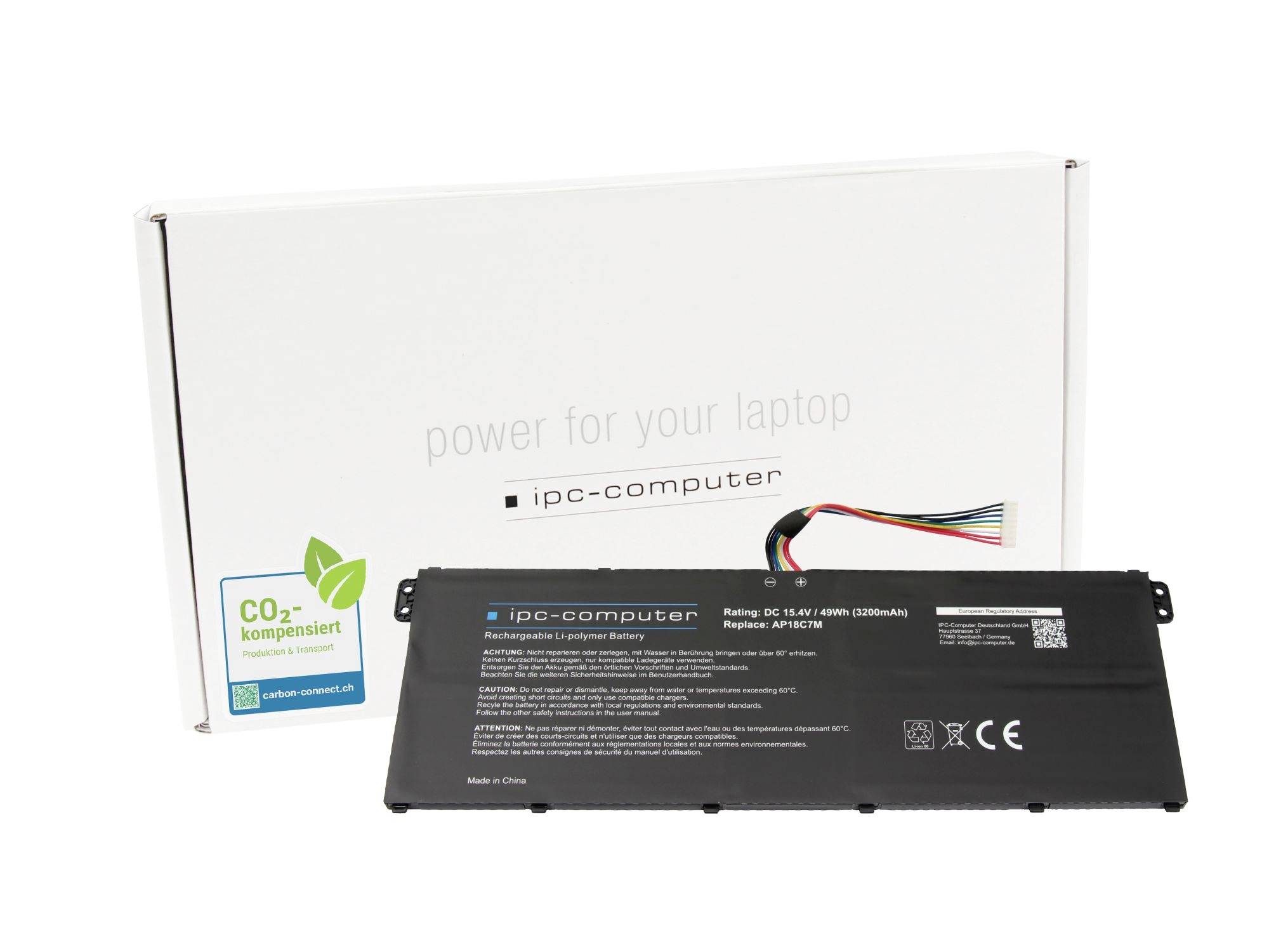 Laptop-Akku in front of its white packaging box labeled 'power for your laptop' and 'ipc-computer', with a CO2-kompensiert sticker.