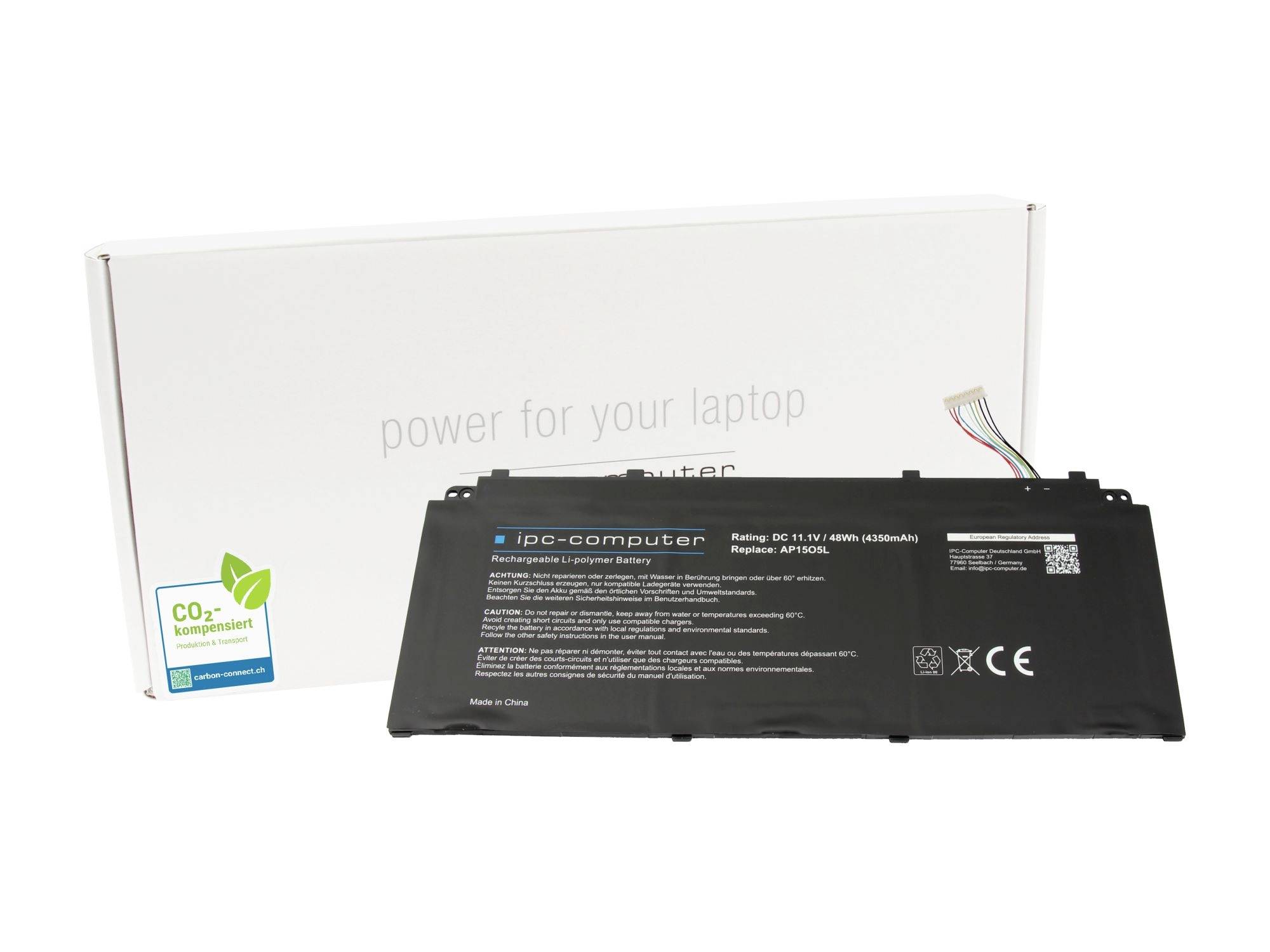 Schwarze Laptop-Batterie vor einer weißen Einzelhandelsbox mit der Aufschrift „Strom für deinen Laptop