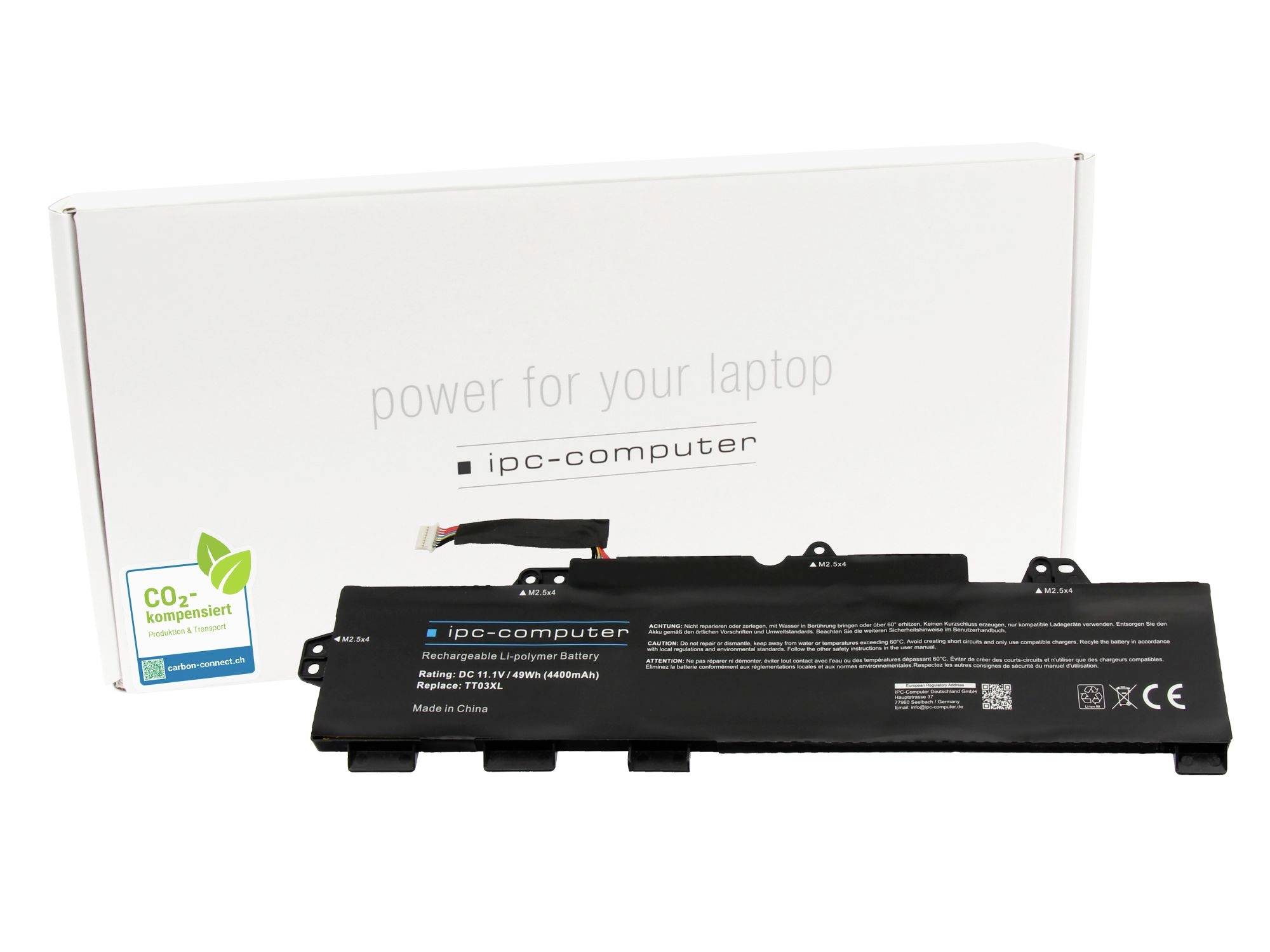 Schwarzes Laptop-Akkupack vor einer weißen Box mit der Aufschrift „Energie für Ihren Laptop