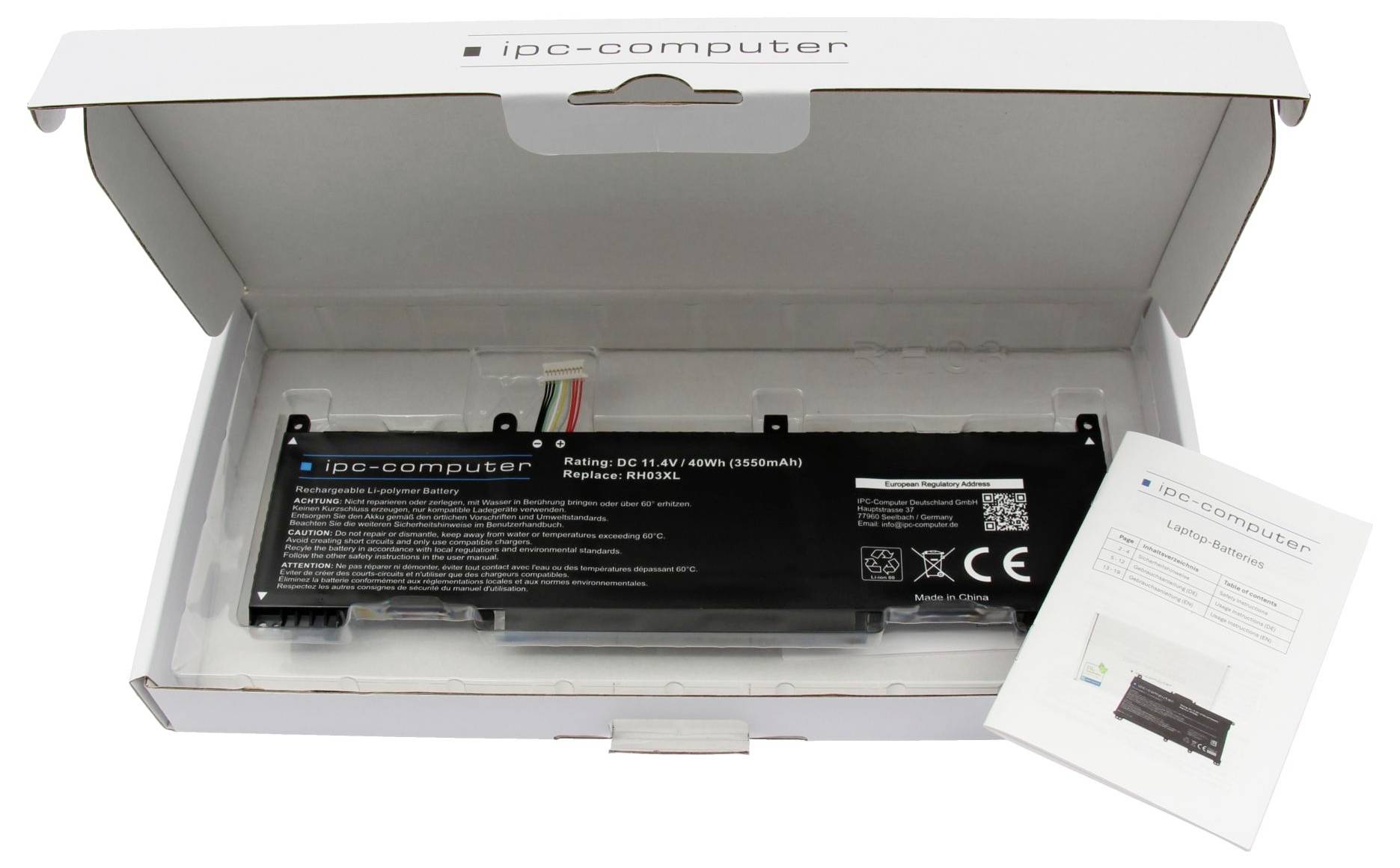 Öffnen Sie die weiße 'ipg-computer' Box mit einer schwarzen wiederaufladbaren Batterie und einem Benutzerhandbuch.