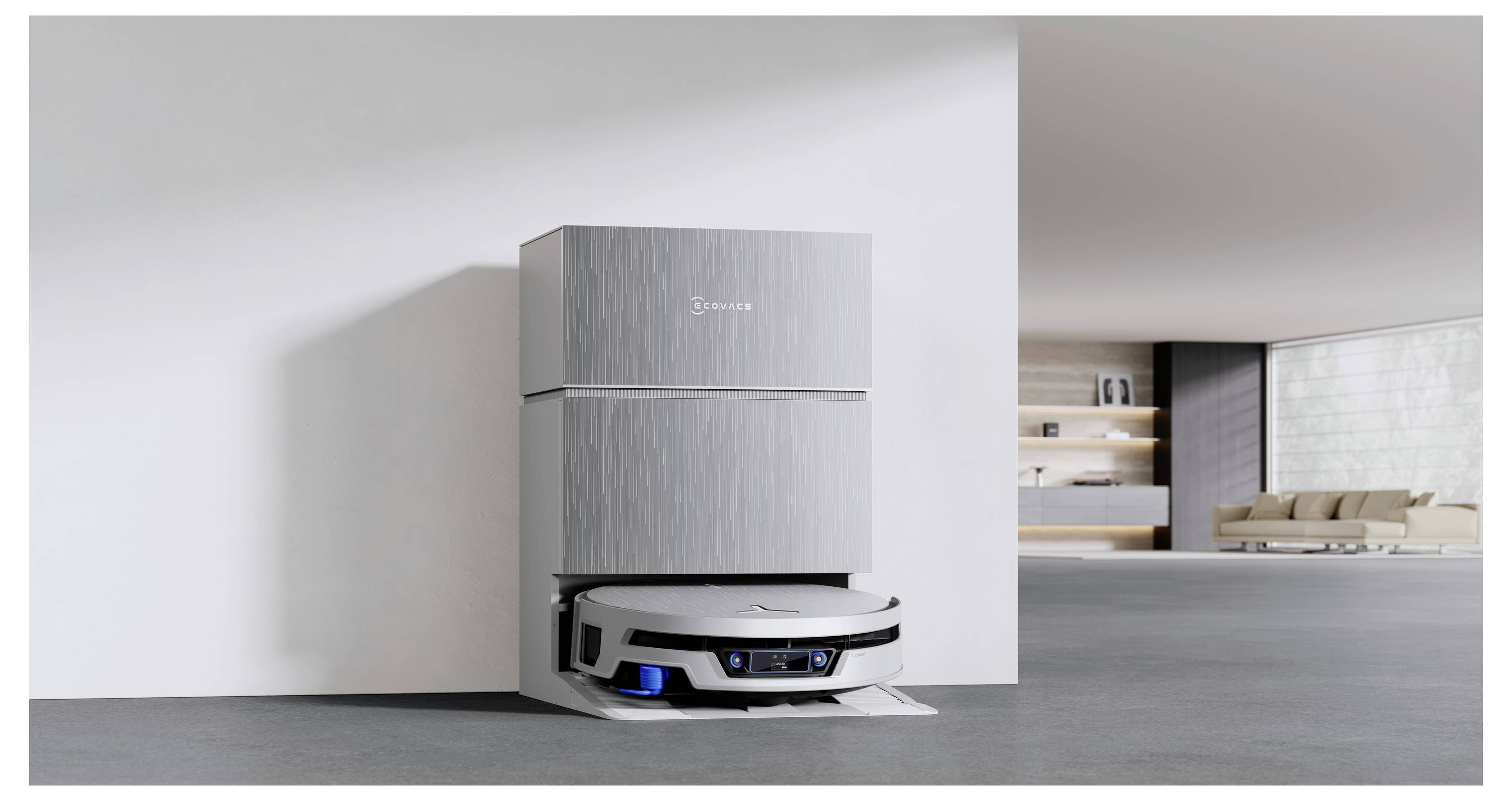 Roboterstaubsauger an einer Ladestation neben einem hohen weißen Gerät in einem modernen, minimalistischen Zimmer angedockt.